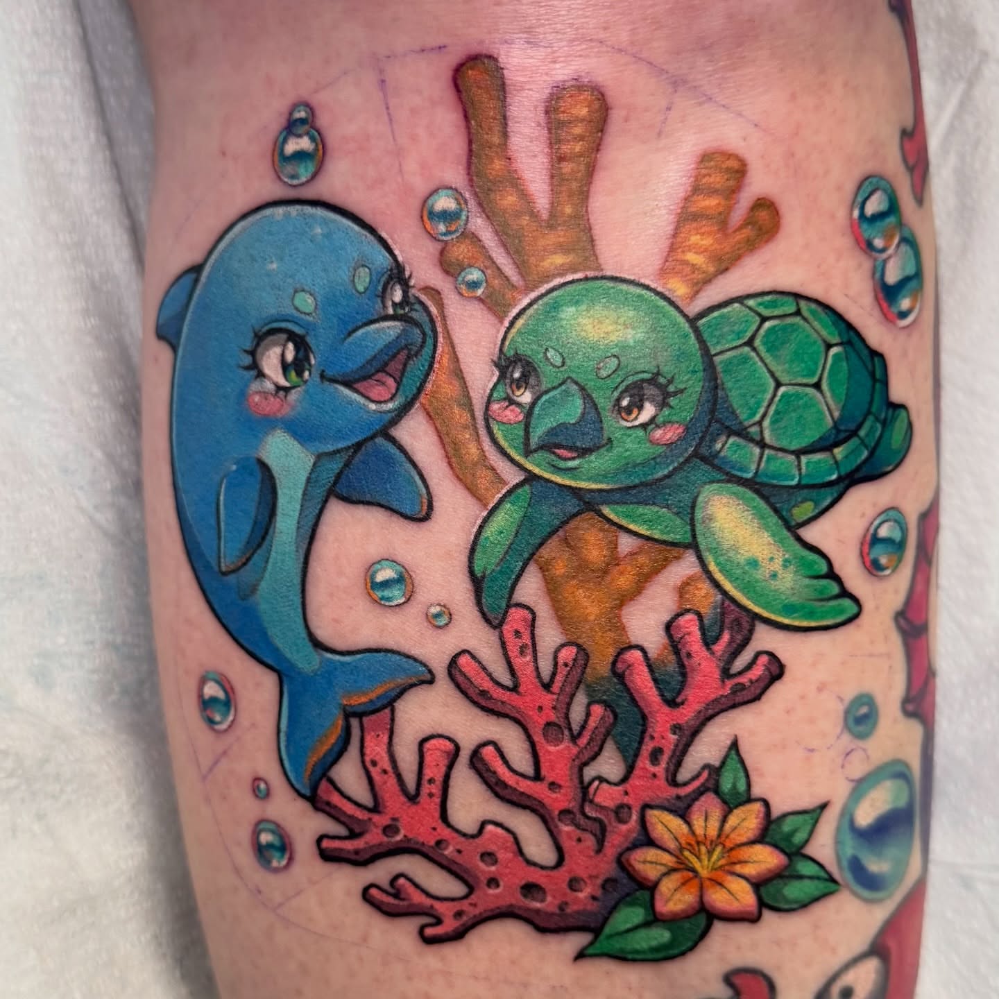 Dolphin and turtle new school tattoo on the forearm by Bri