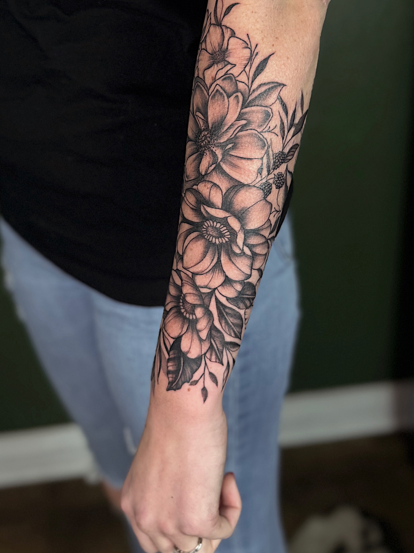 Floral bouquet black and grey tattoo on the forearm by Breanna Werner