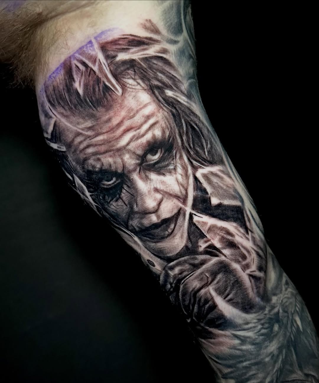 The Joker portrait realism tattoo on the forearm by Comfy Chris Fettig