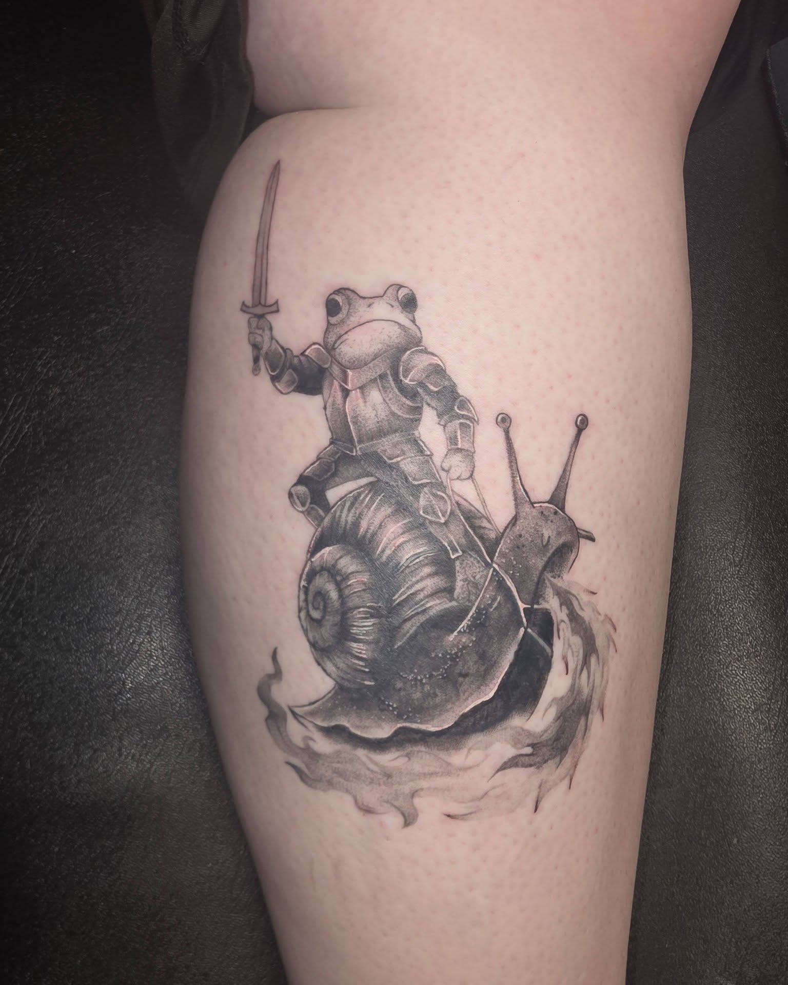 Frog knight riding snail realism tattoo on the thigh by Jessica DarkRabbit