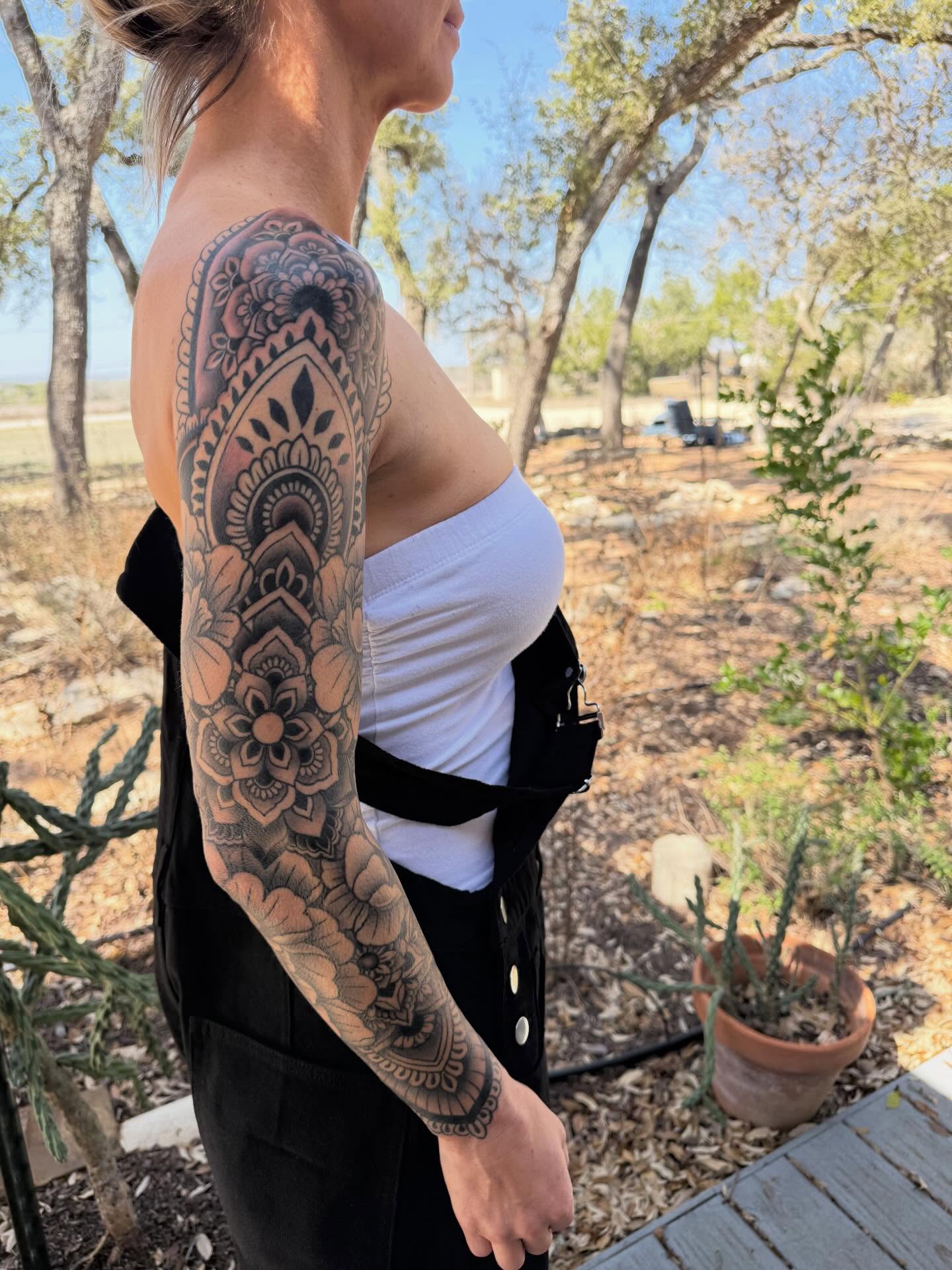 Floral mandala ornamental tattoo on the upper arm by Rebecca Basma Smith