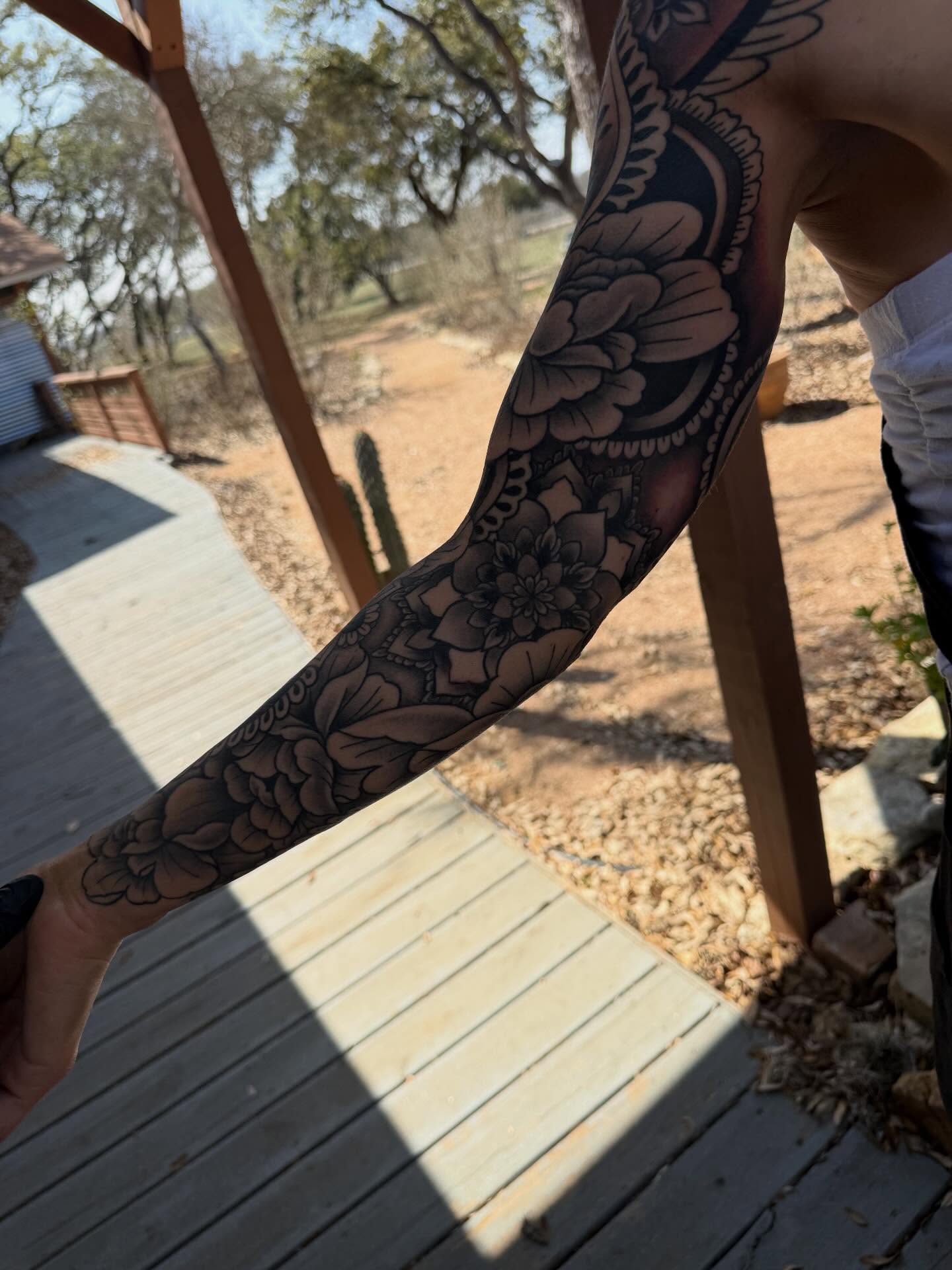 Floral black and grey tattoo on the forearm by Rebecca Basma Smith