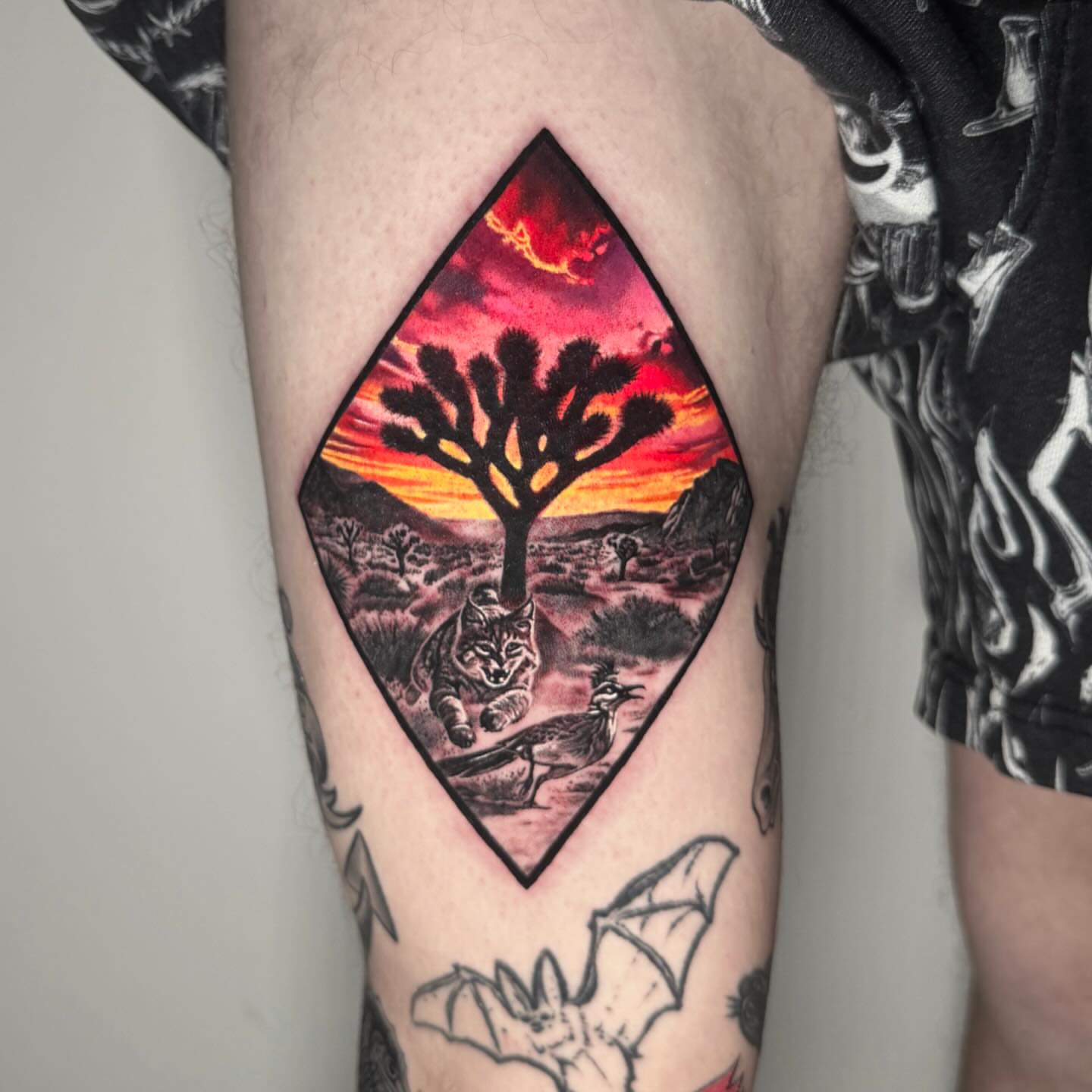 Desert landscape realism tattoo on the thigh by TJ Schunemann