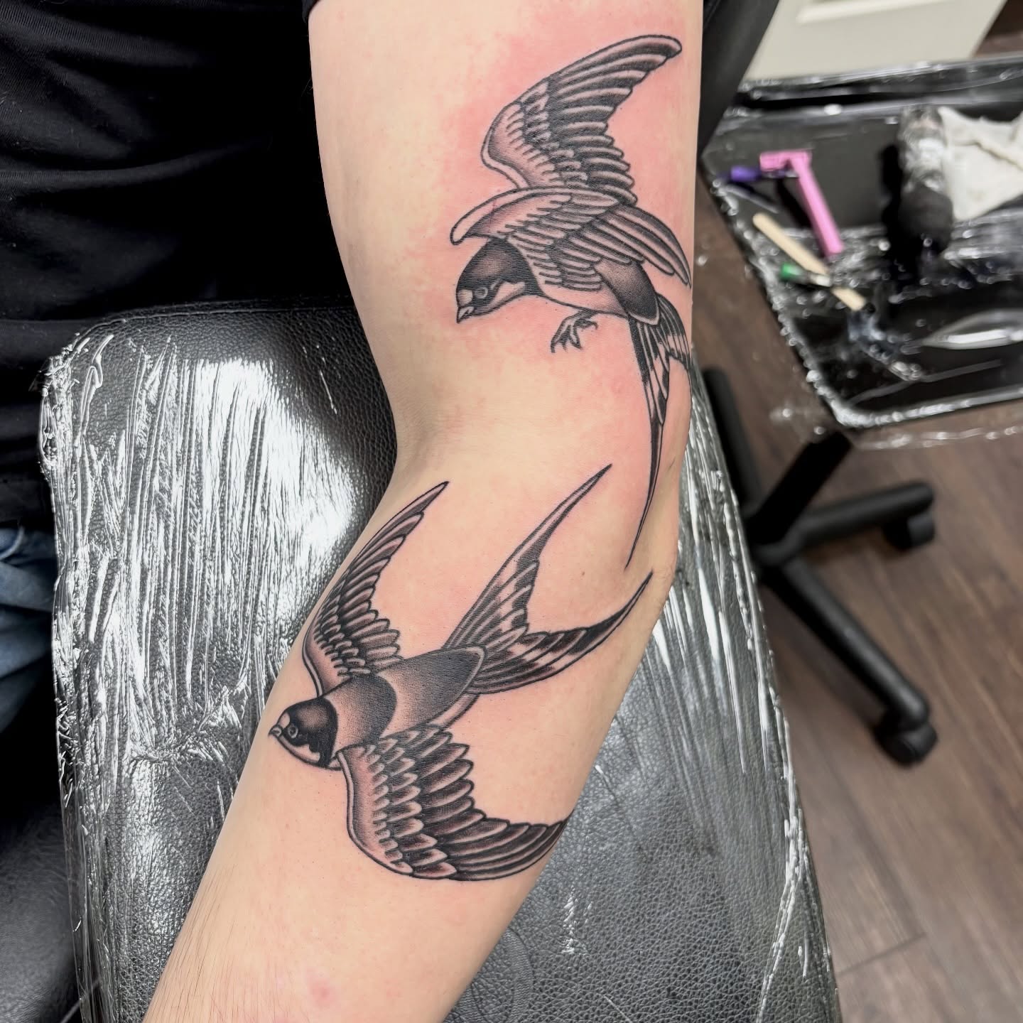 Swallows black and grey tattoo on the forearm by sydney honn