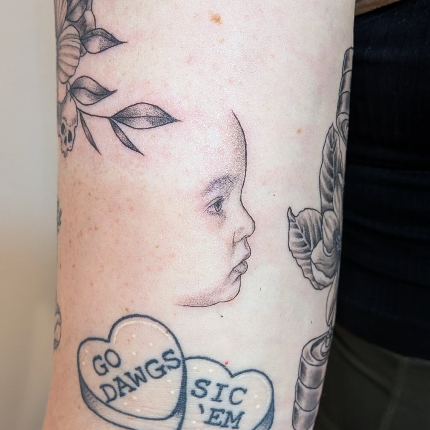 Child's face realism tattoo on the forearm by L U C y, Knoxville, Tennessee