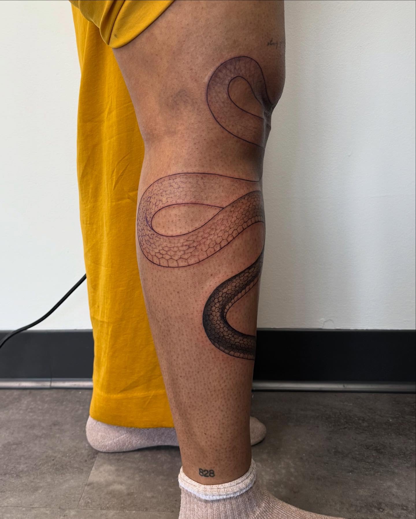 Snake black and grey tattoo on the calf by Carson Mccullers ✨