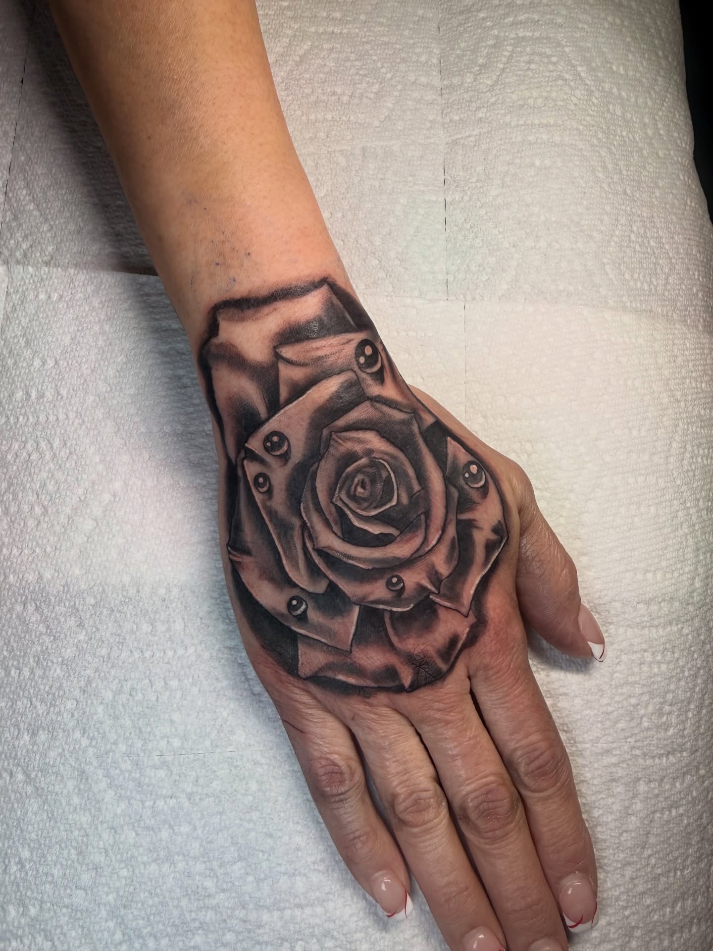 Rose realism tattoo on the hand by Ashley Laine Evans
