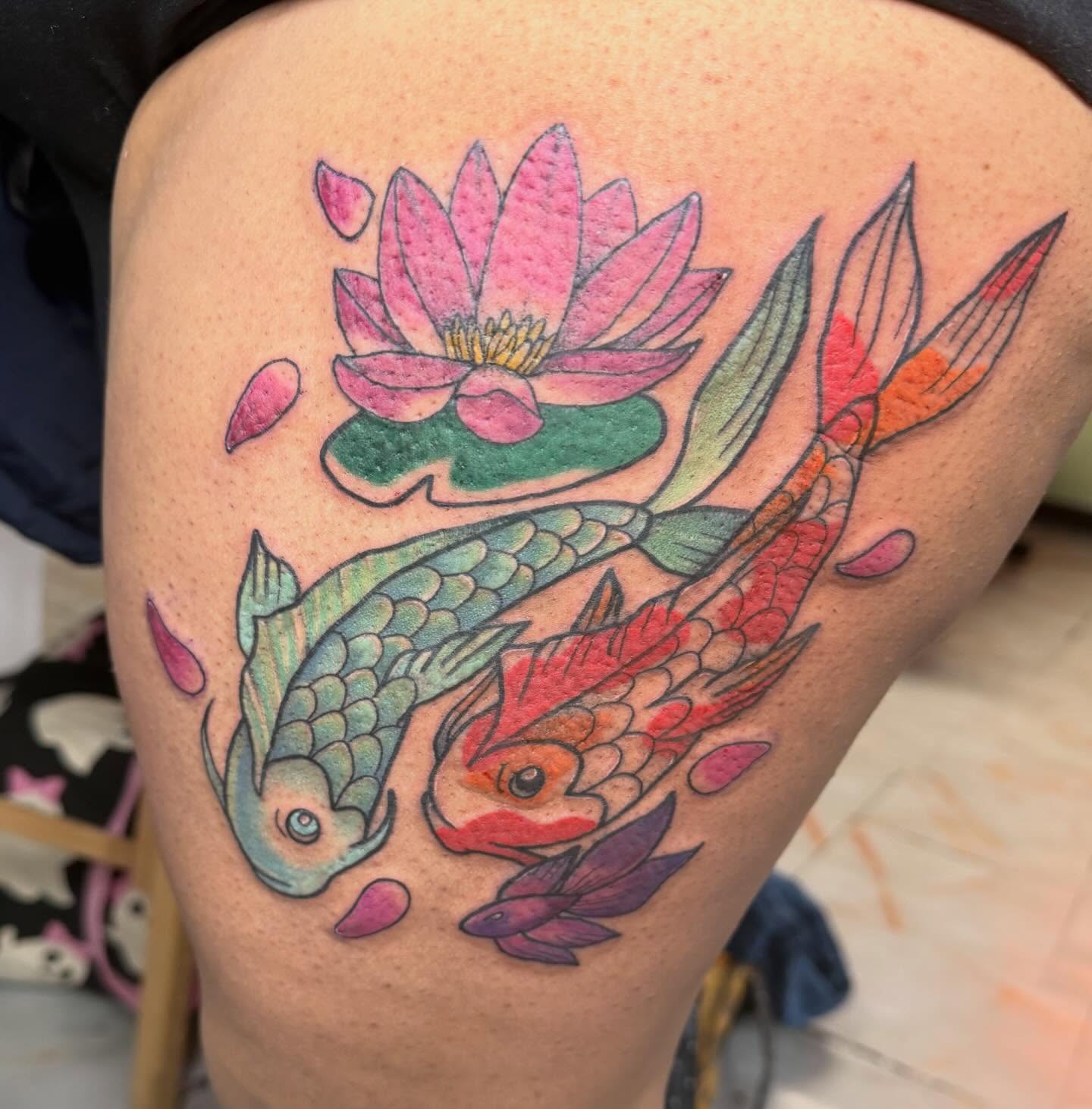 Koi fish and lotus American traditional tattoo on the thigh by Abby