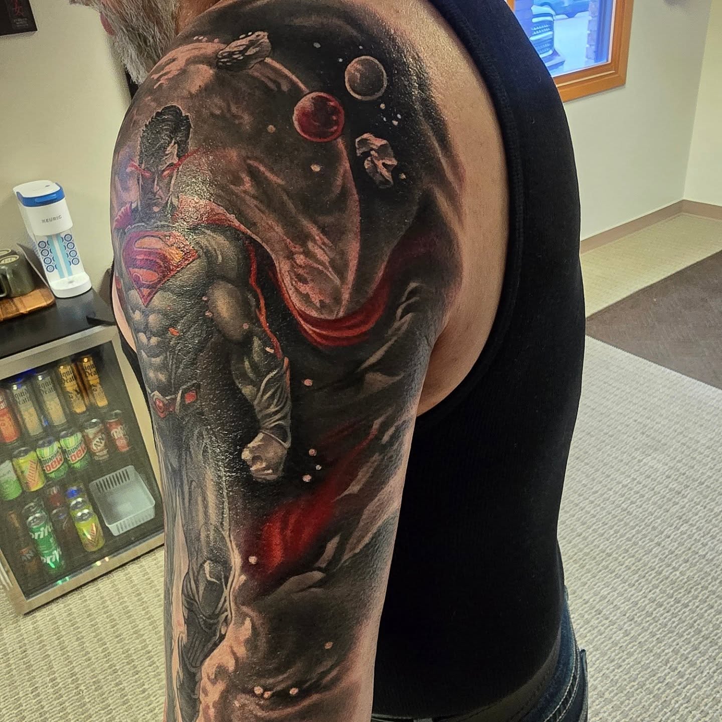 Superman realism tattoo on the upper arm by Alexander L. Wolff, Rapid City, South Dakota