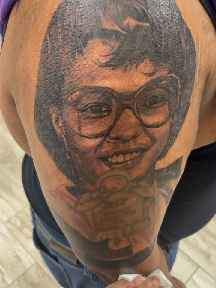 Portrait realism tattoo on the shoulder by Quinten Harper