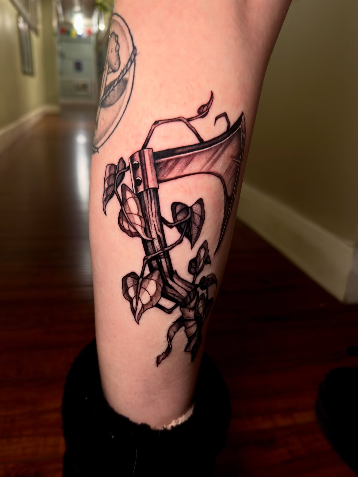 Axe and ivy black and grey tattoo on the forearm by Marisa Biddle
