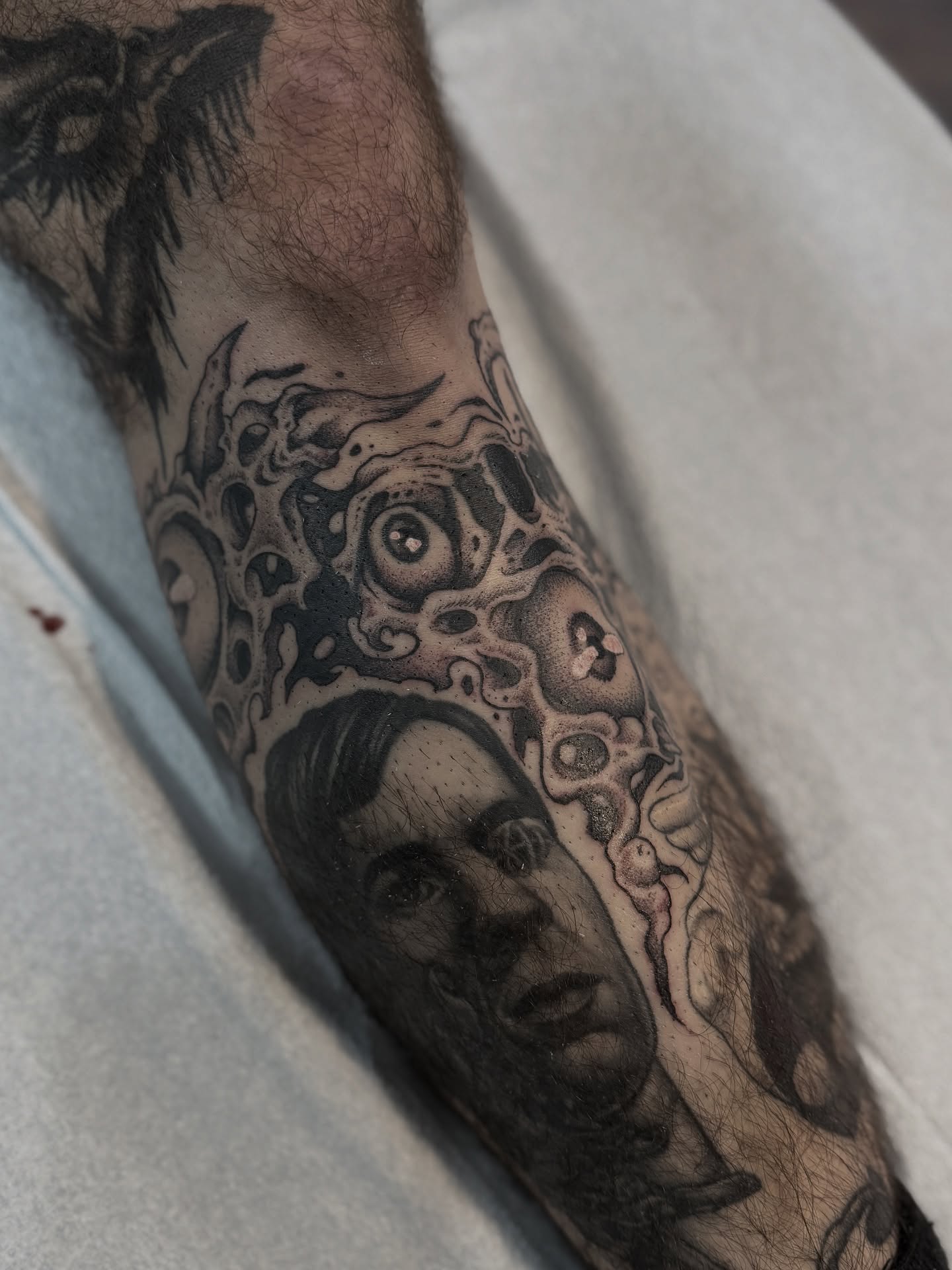 Portrait with surreal elements surrealism tattoo on the forearm by Andrew