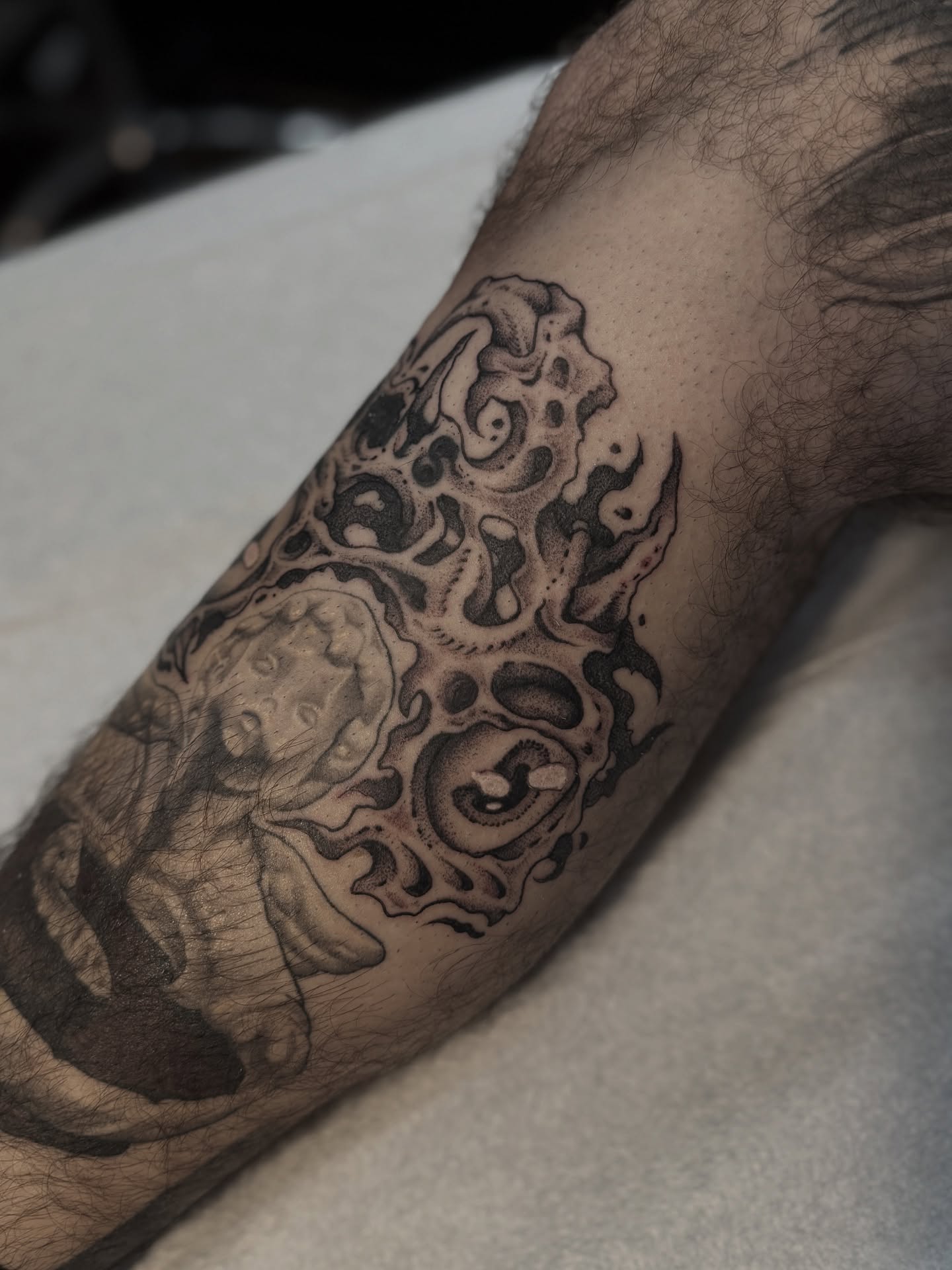 Octopus black and grey tattoo on the forearm by Andrew