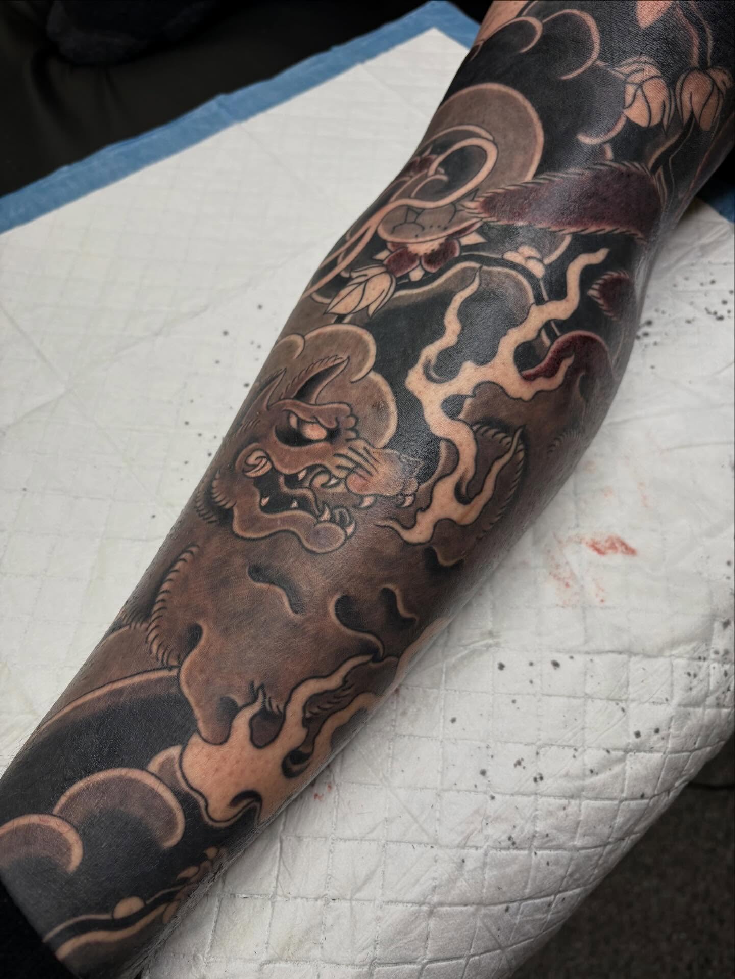 Lion and clouds japanese irezumi tattoo on the forearm by Zach Hendrickson