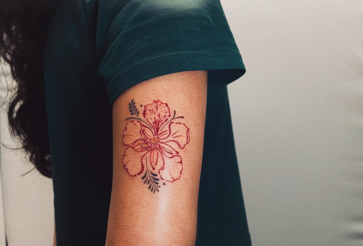 Hibiscus flower geometric tattoo on the forearm by vivian