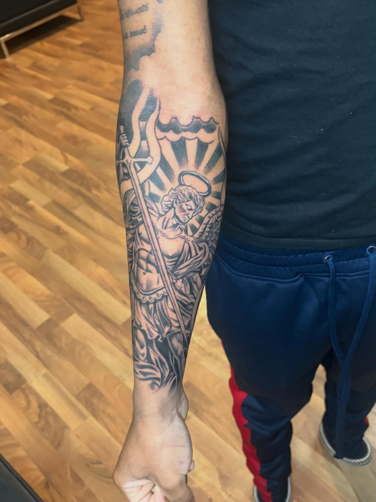 Angel with sword black and grey tattoo on the forearm by 𓂀 𝕊ℍ𝔼𝕃𝕃𝕐 𓂀