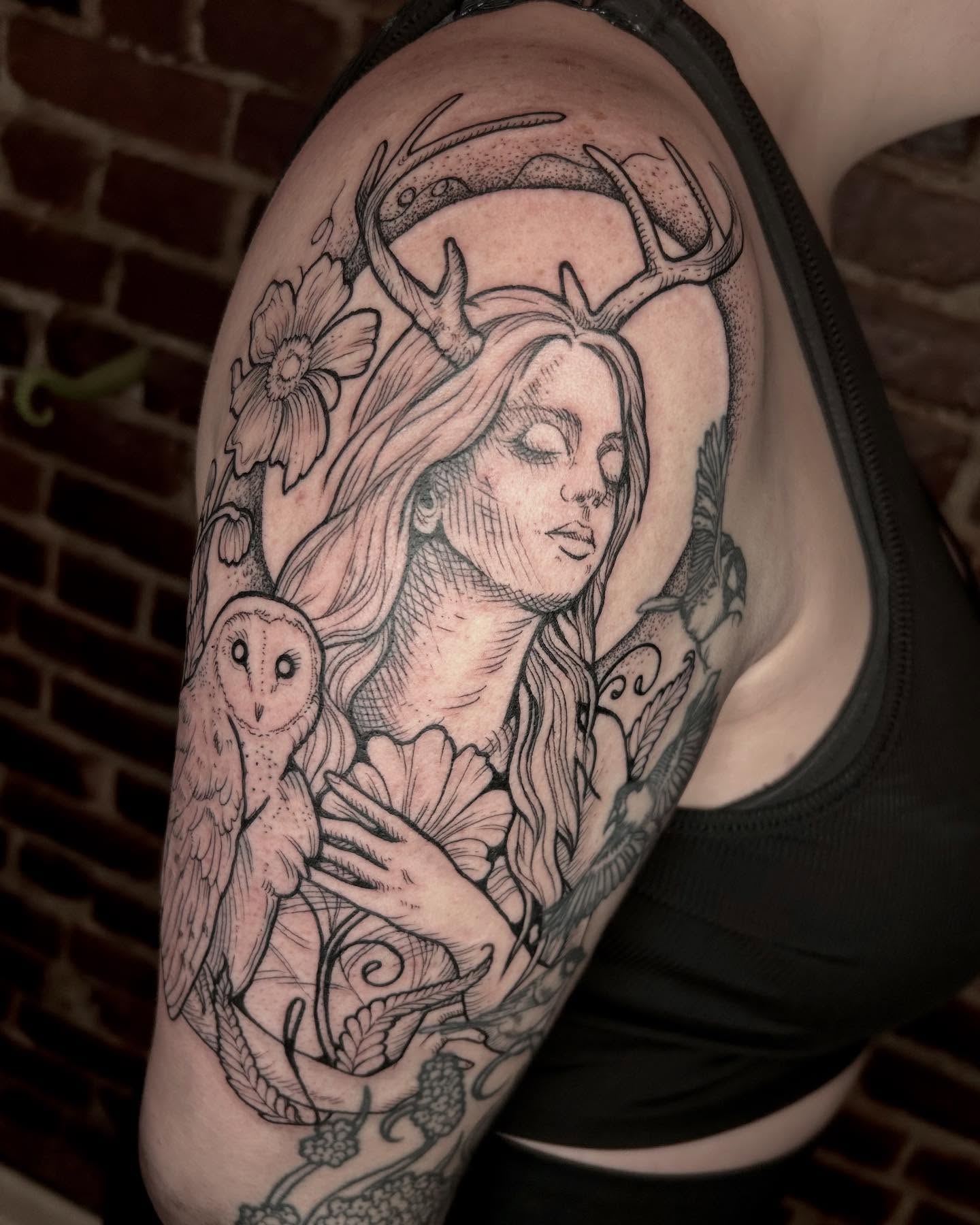 Woman with deer antlers realism tattoo on the shoulder by Deanna Louise