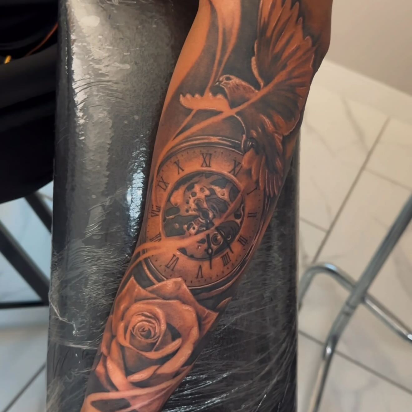 Clock, bird, rose realism tattoo on the forearm by Adrian gonzalez...