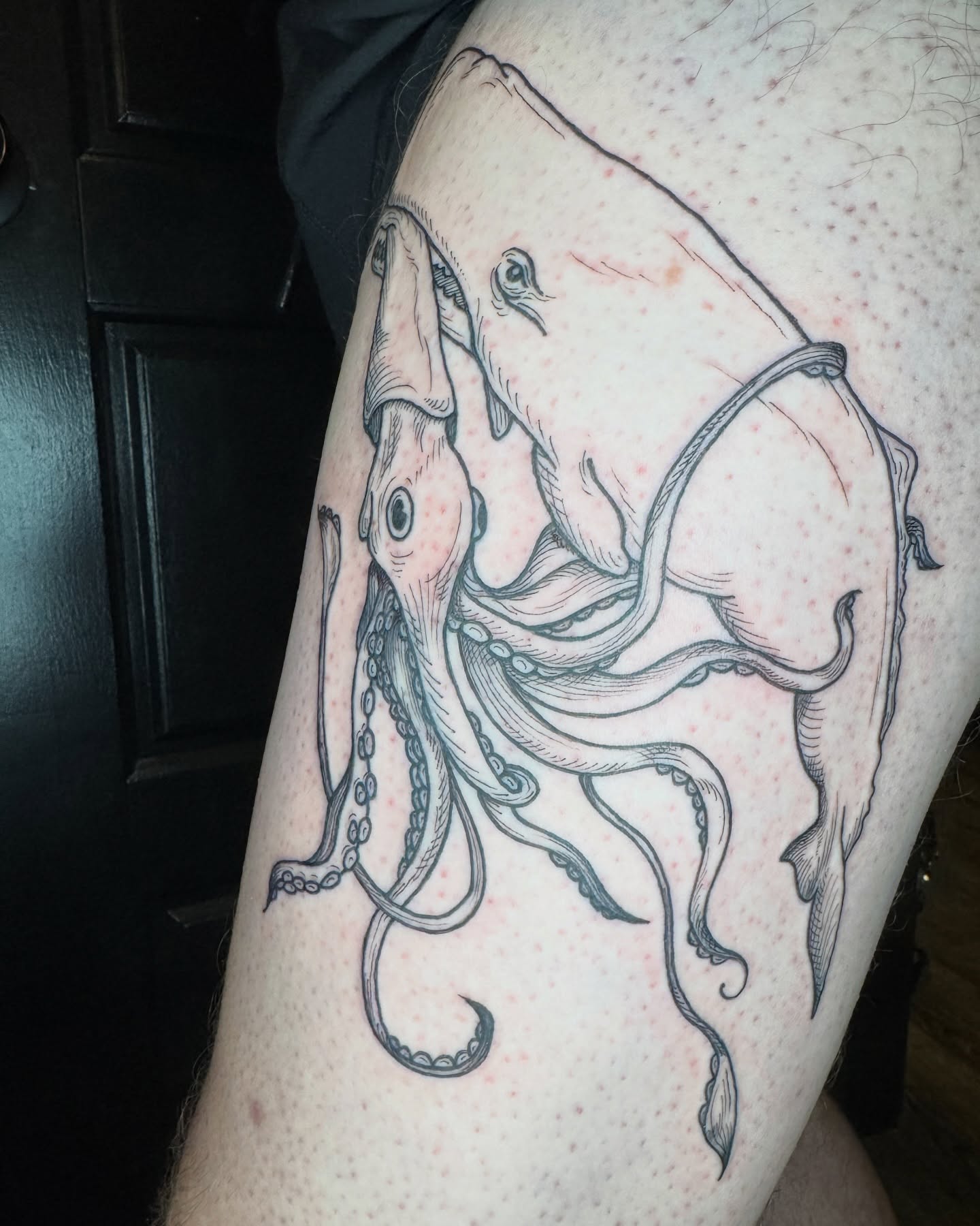 Octopus black and grey tattoo on the thigh by Lora Bird