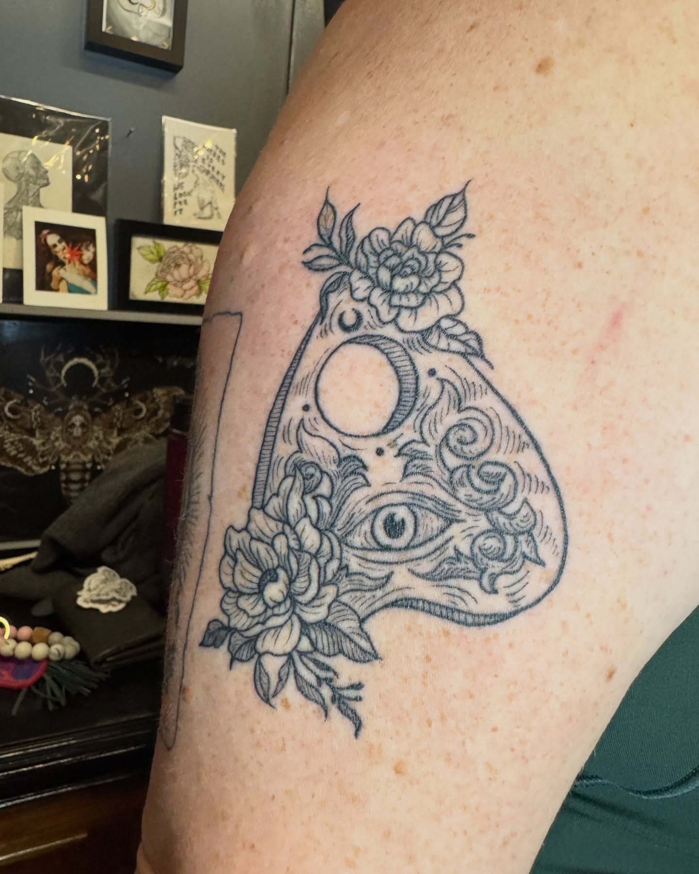 Eye and floral design ornamental tattoo on the thigh by Lora Bird