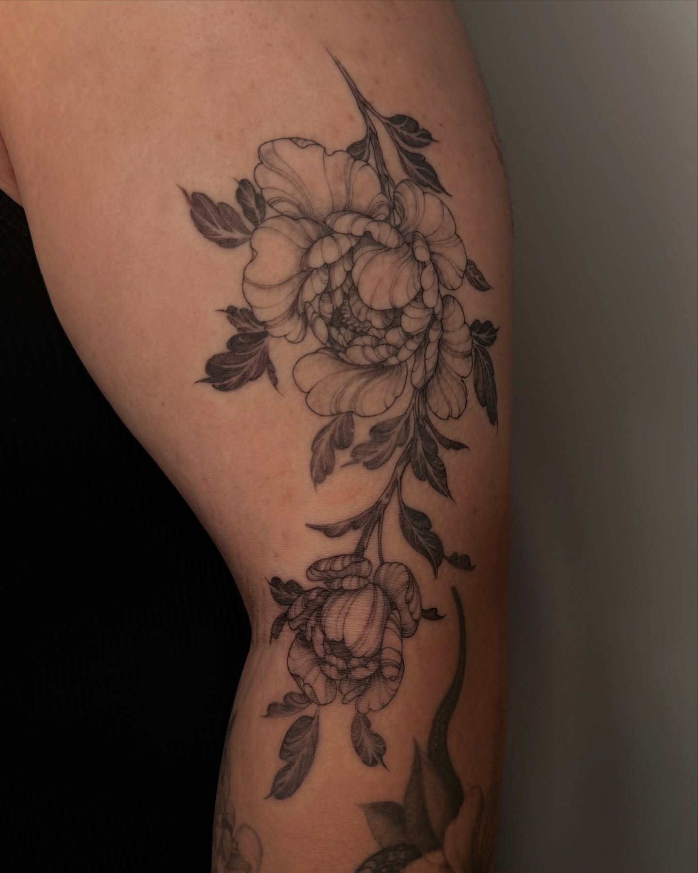 Peony flowers black and grey tattoo on the forearm by Sab