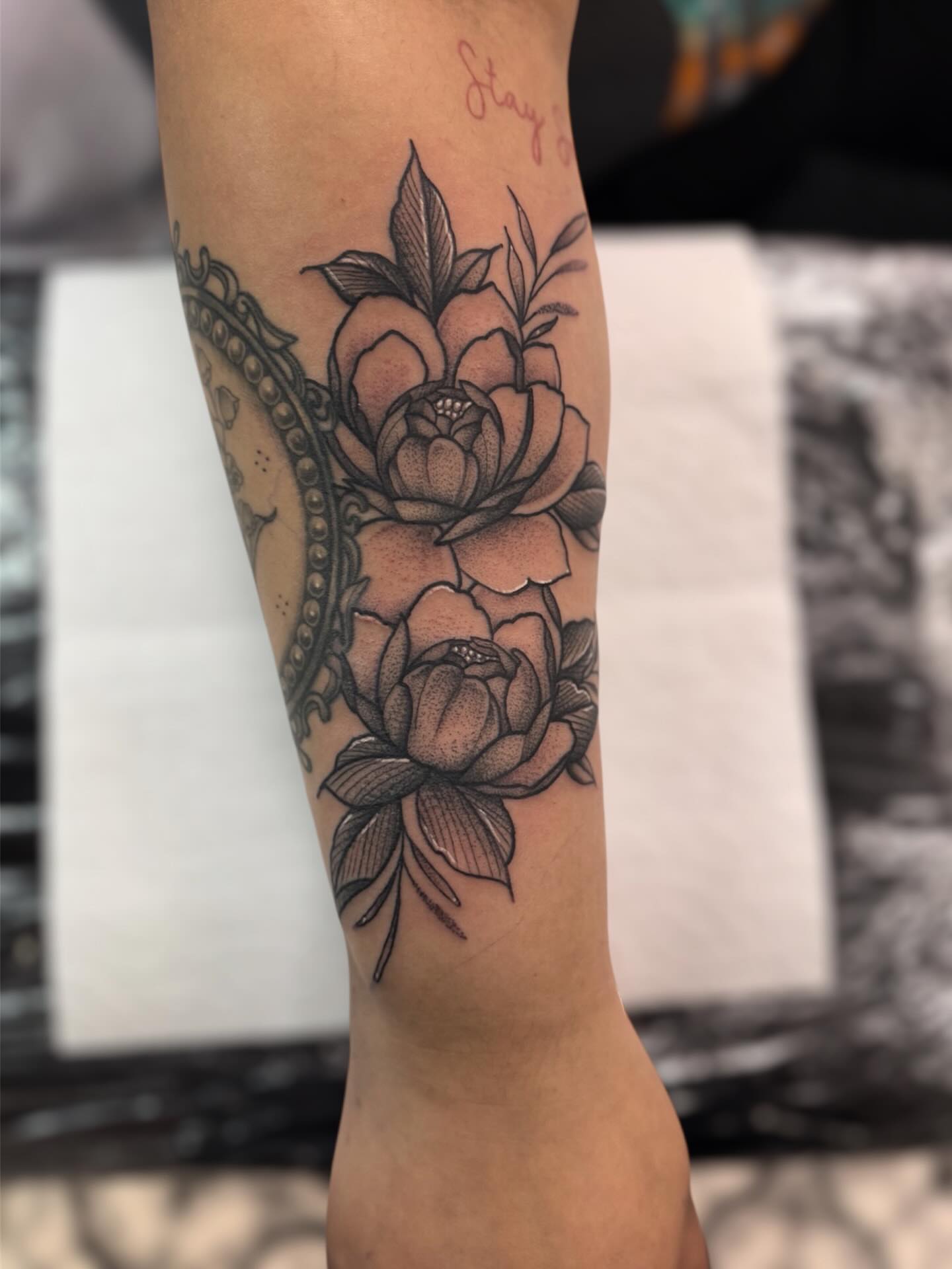 Peonies black and grey tattoo on the forearm by Ashleigh Lapole