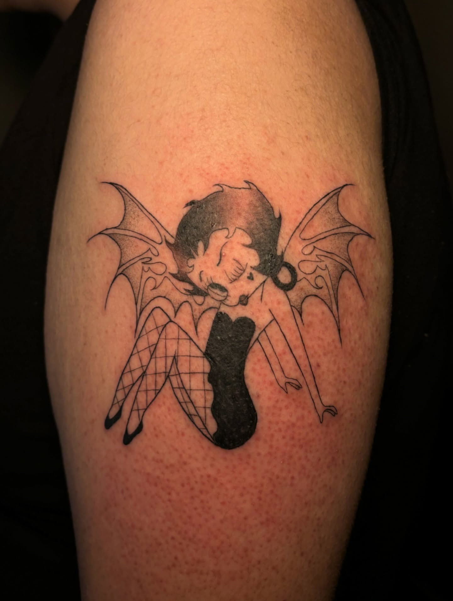 Batgirl black and grey tattoo on the upper arm by the ink witch ๐ฎ๐ค๐