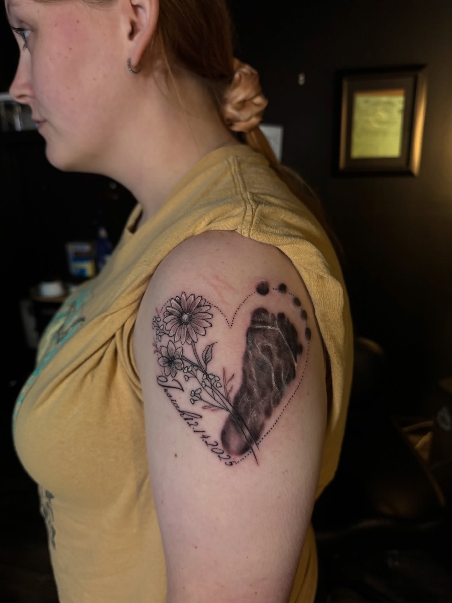 Heart with floral and feather dotwork tattoo on the shoulder by Elijah Tattoos, San Diego, California