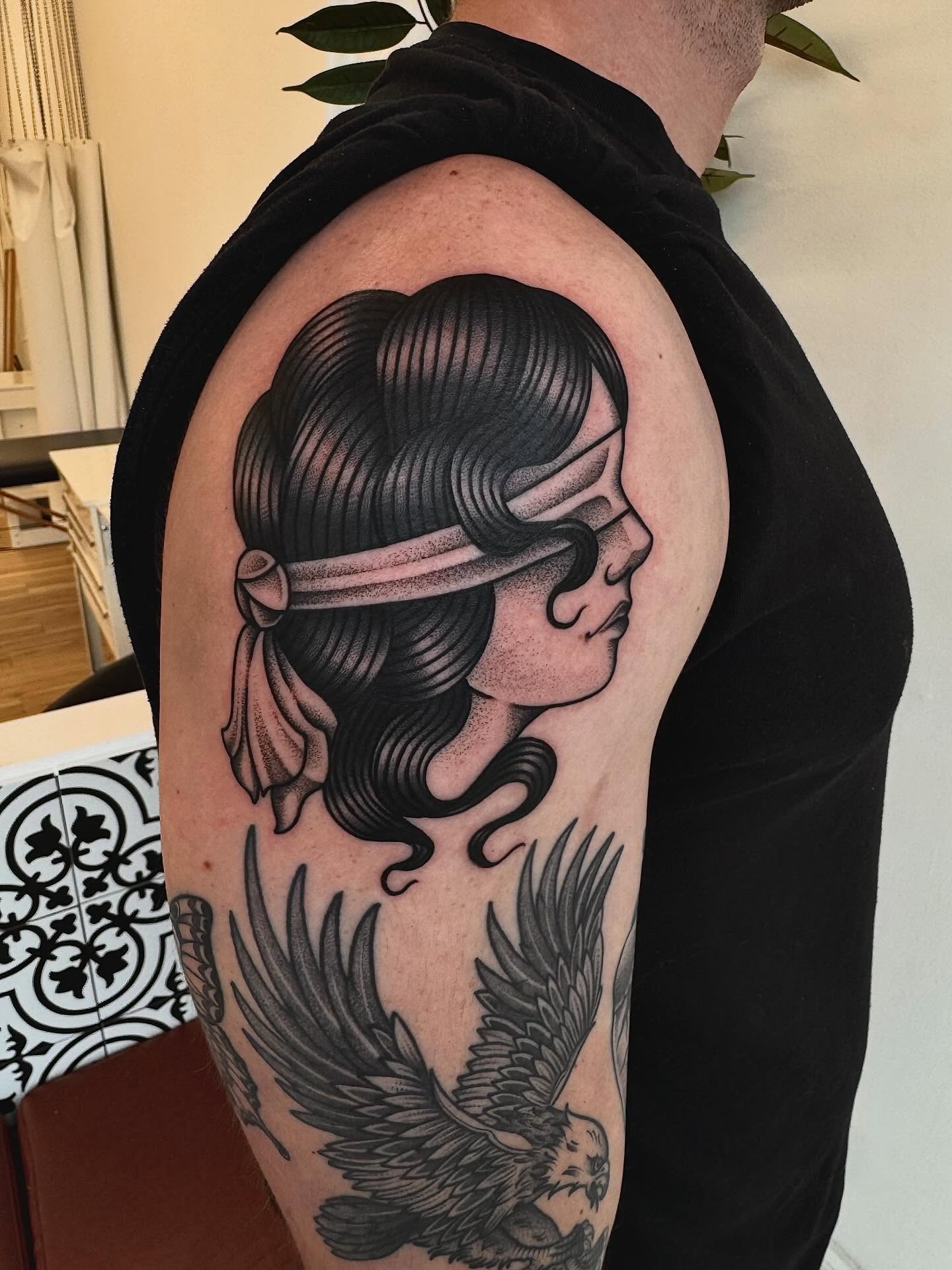 Woman with eagle American traditional tattoo on the upper arm by Stefany