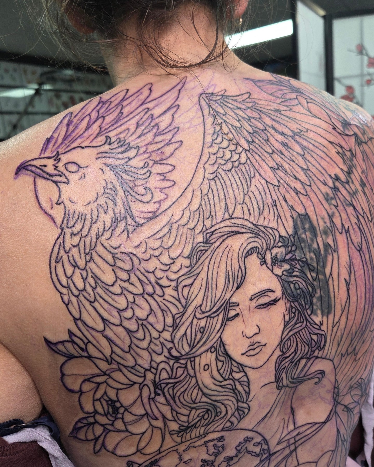 Phoenix and woman realism tattoo on the back by Trinity Renee