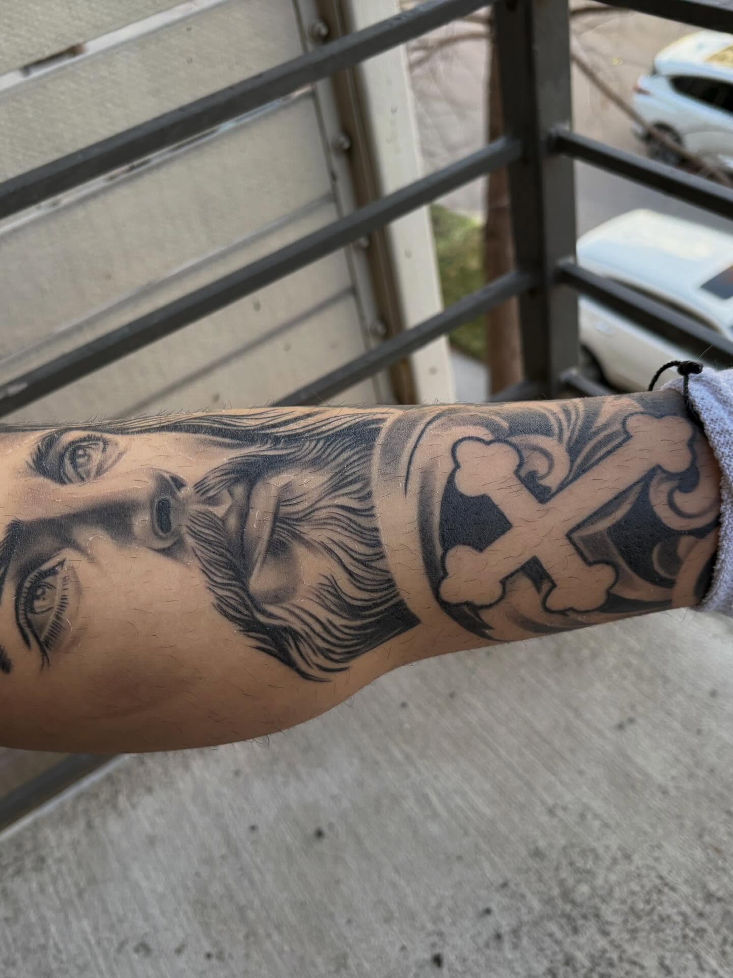 Religious figure black and grey tattoo on the forearm by Devin
