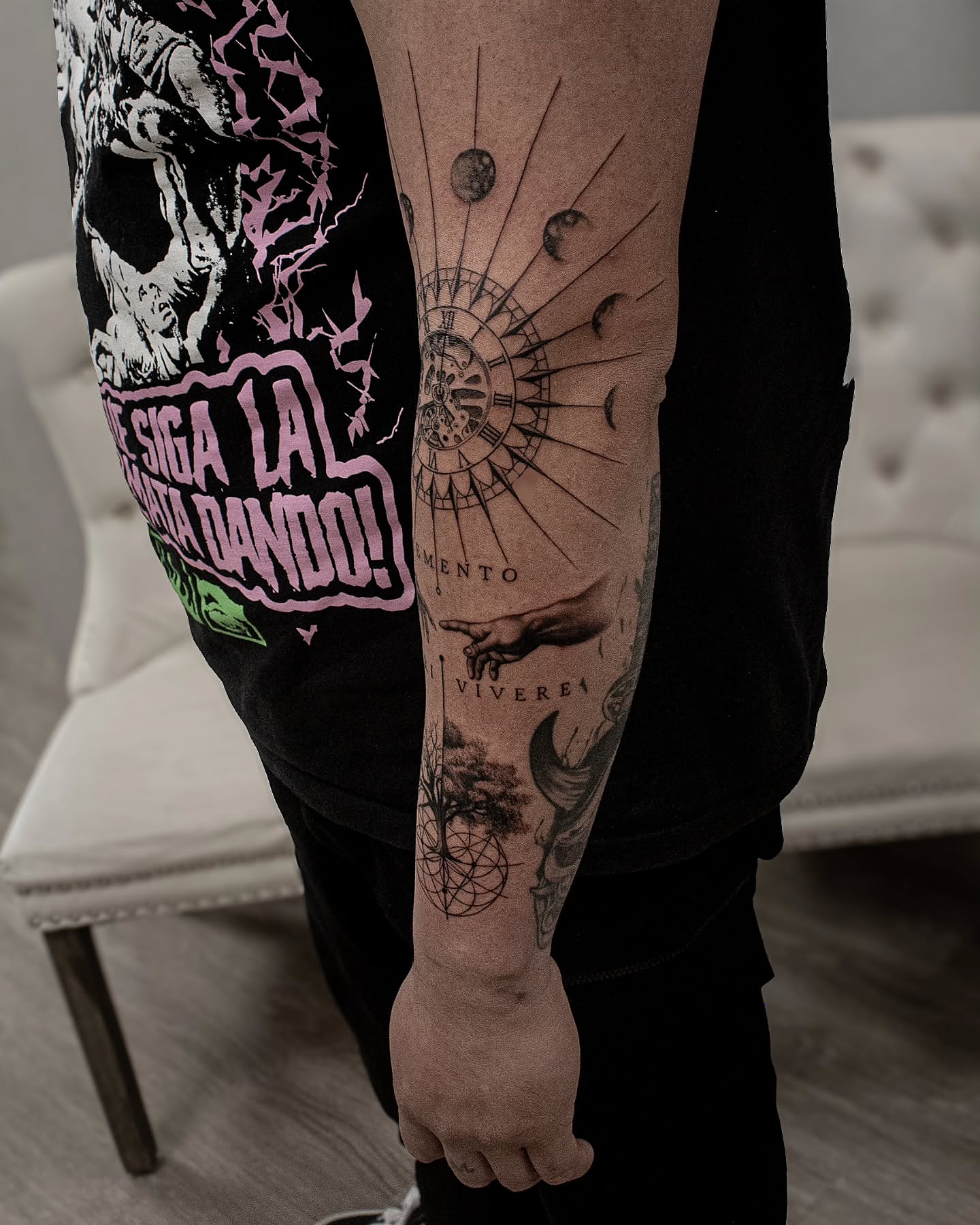 Astronomical clock black and grey tattoo on the forearm by Erik Bonilla