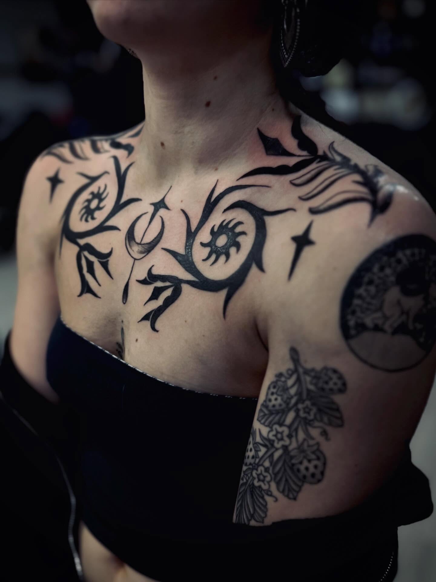 Astral symbols tribal tattoo on the chest by Katelyn Arnold
