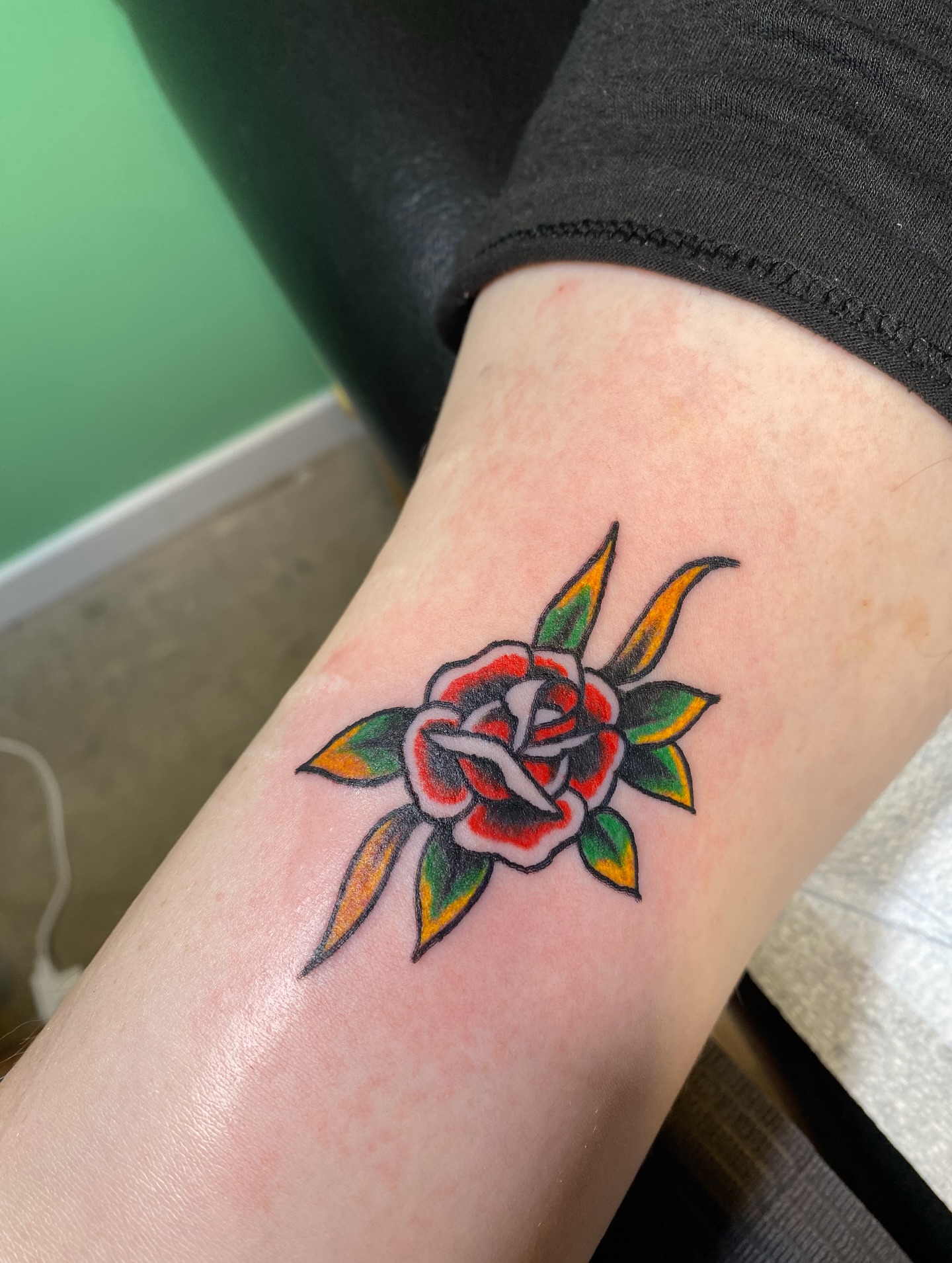 Rose American traditional tattoo on the forearm by Karl Hegwein, Portland, Oregon
