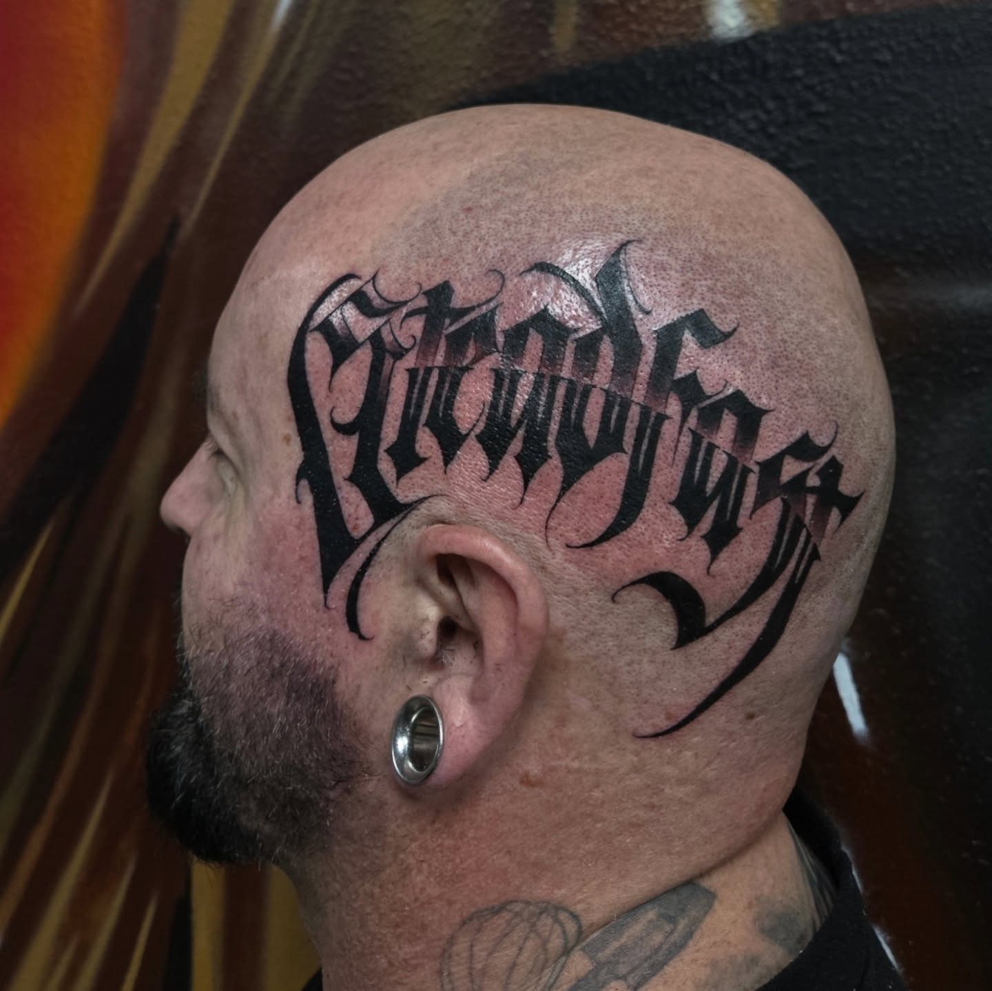 Gothic script lettering script tattoo on the head by DiazTattoos, Denver, Colorado
