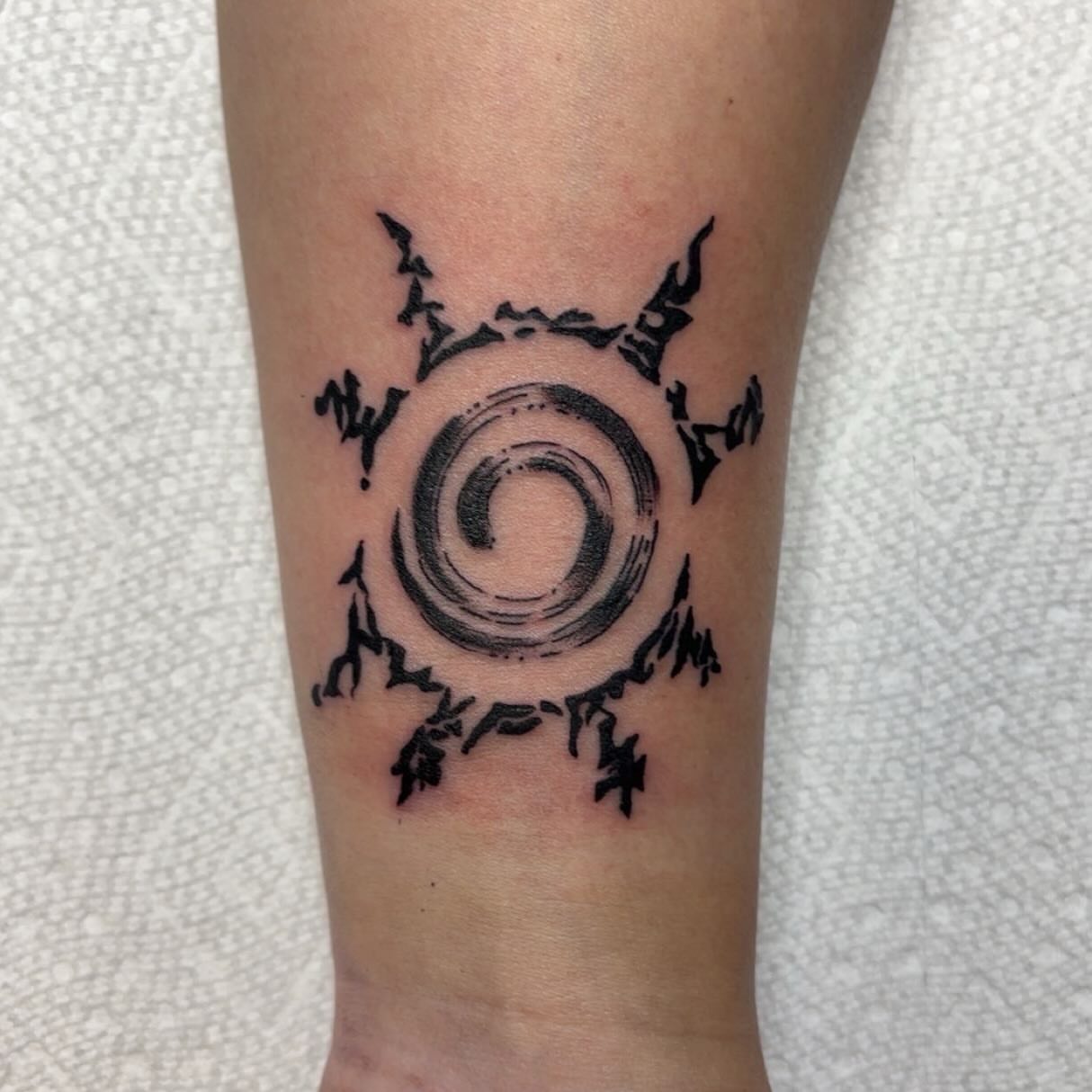 Swirling spiral dotwork tattoo on the forearm by Molly Dixon