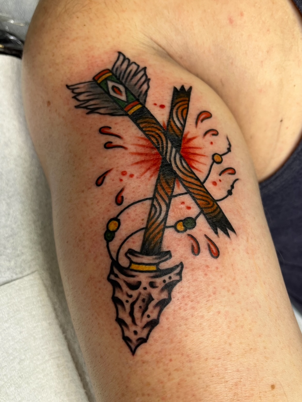 Crossbow American traditional tattoo on the shoulder by Macy Bird