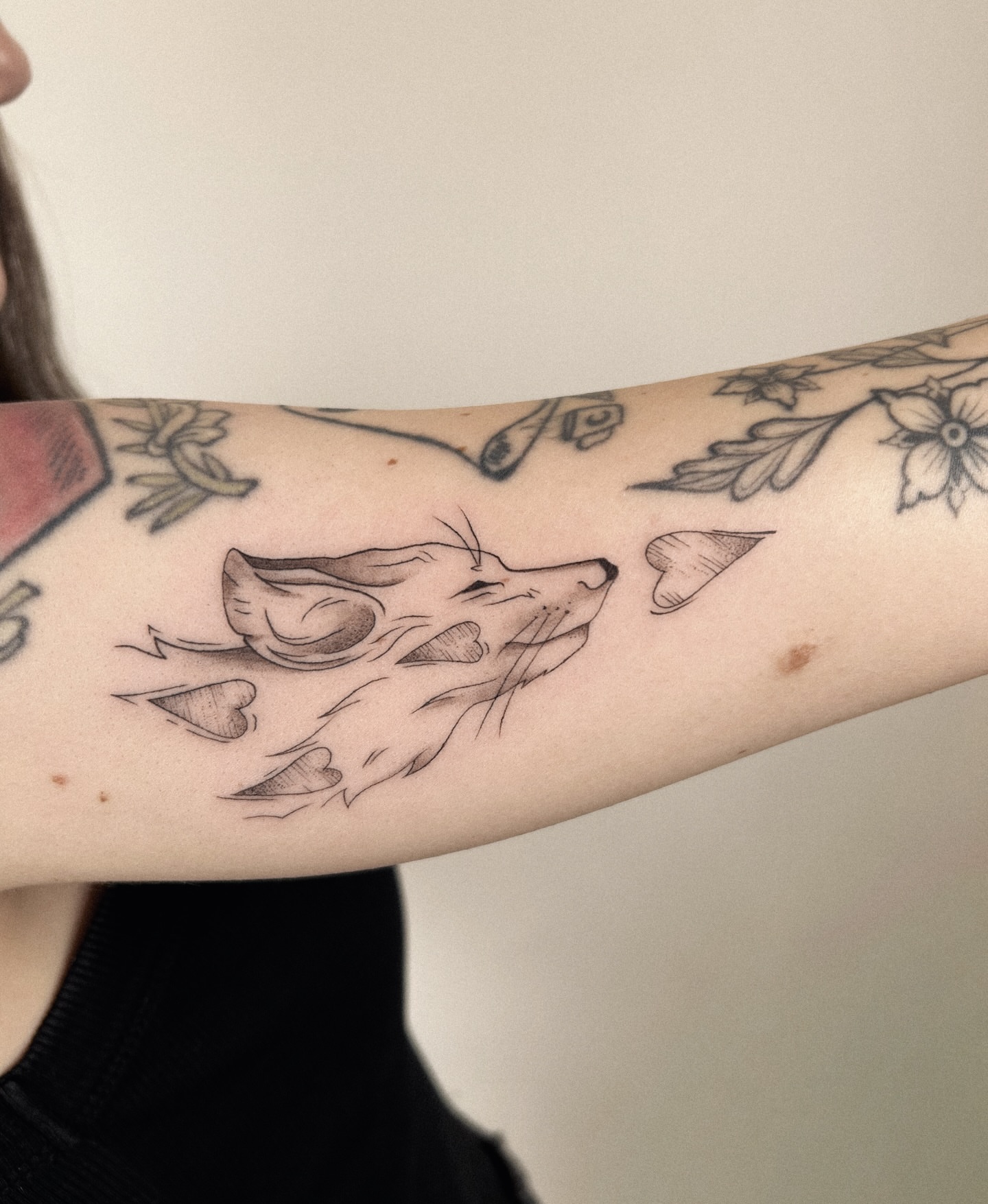 Wolf black and grey tattoo on the forearm by Helly March