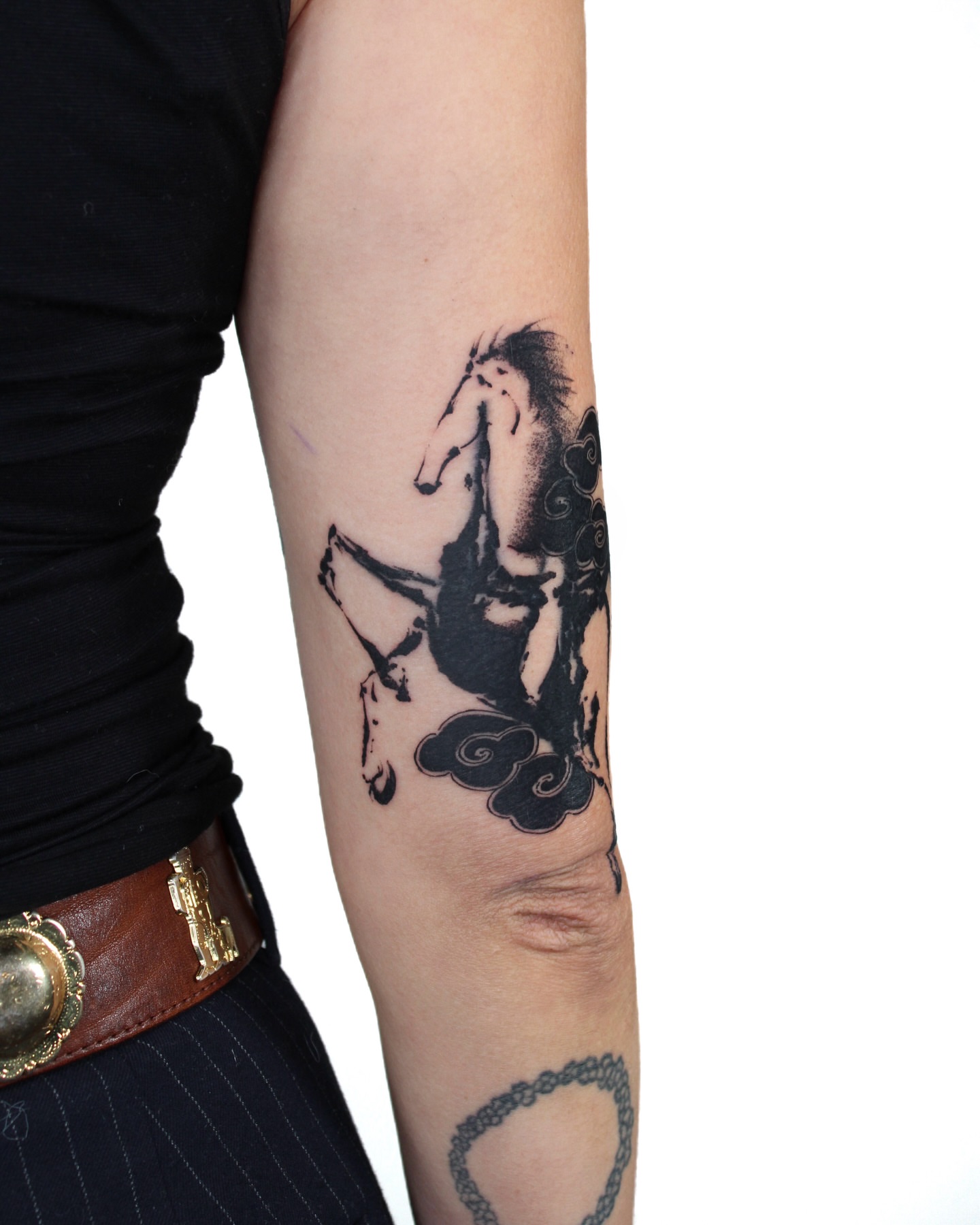 Horse and rider black and grey tattoo on the forearm by Piao