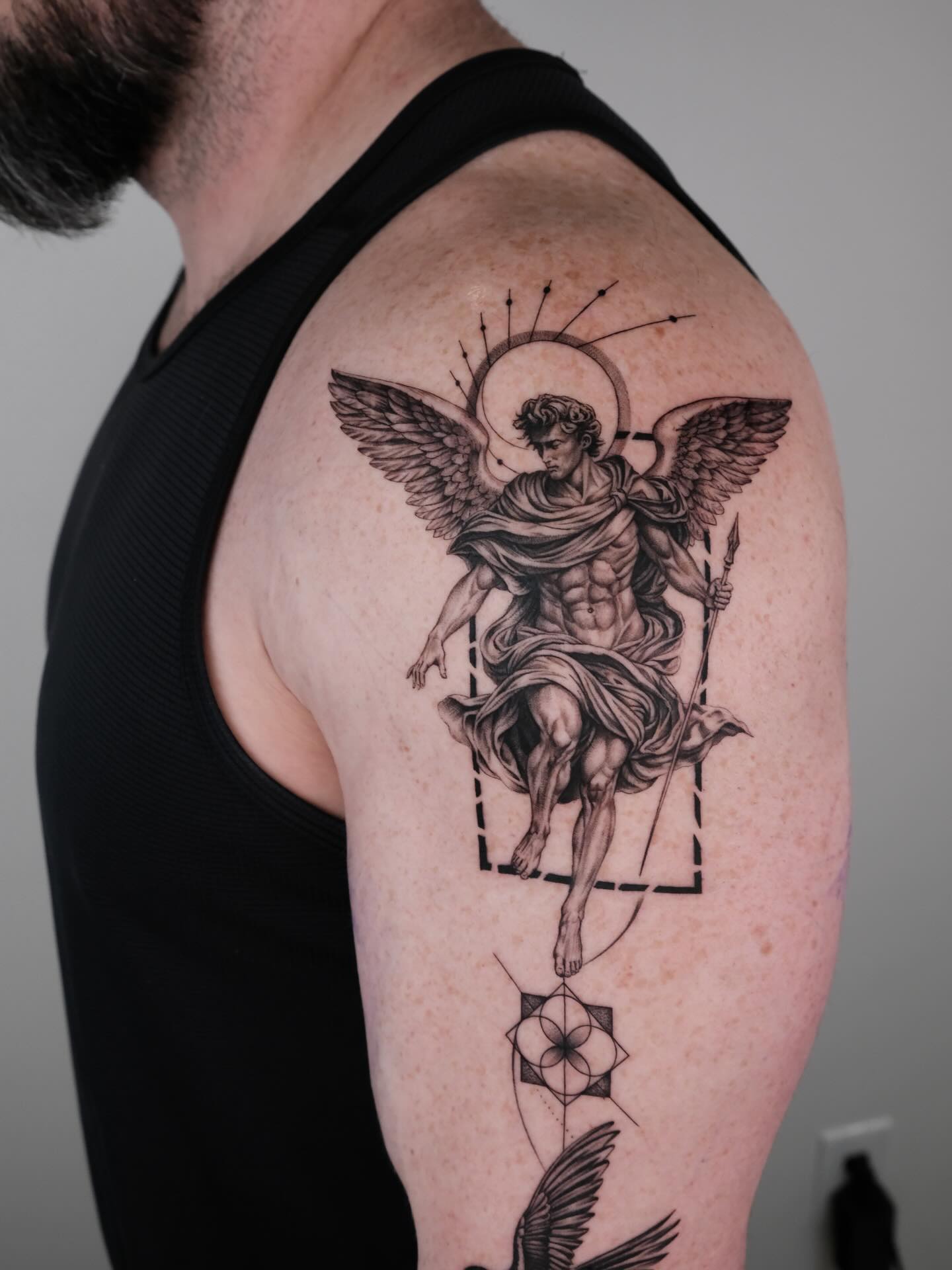 Angel with spear and geometric elements realism tattoo on the shoulder by Zay - Realistic tattoo Artist