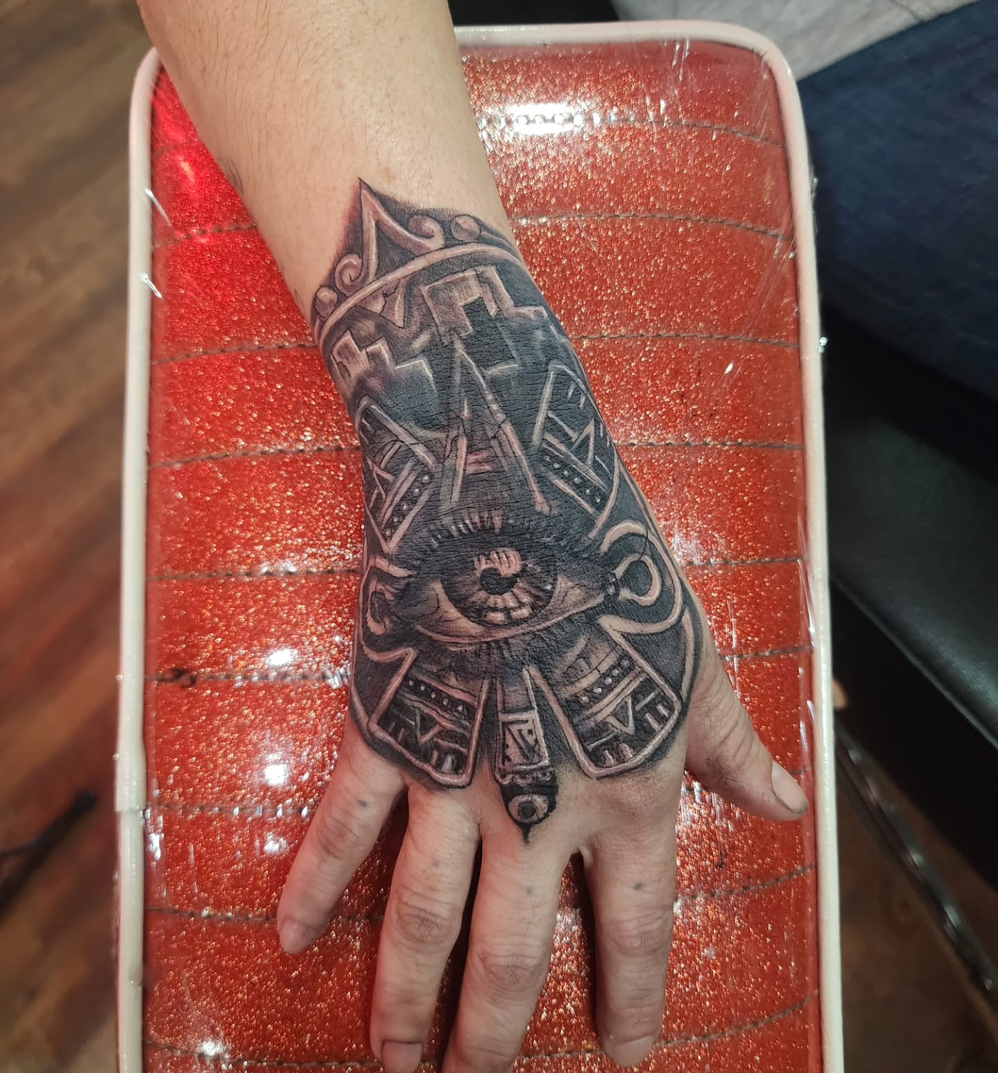 Eye and geometric patterns geometric tattoo on the hand by Joe Garcia
