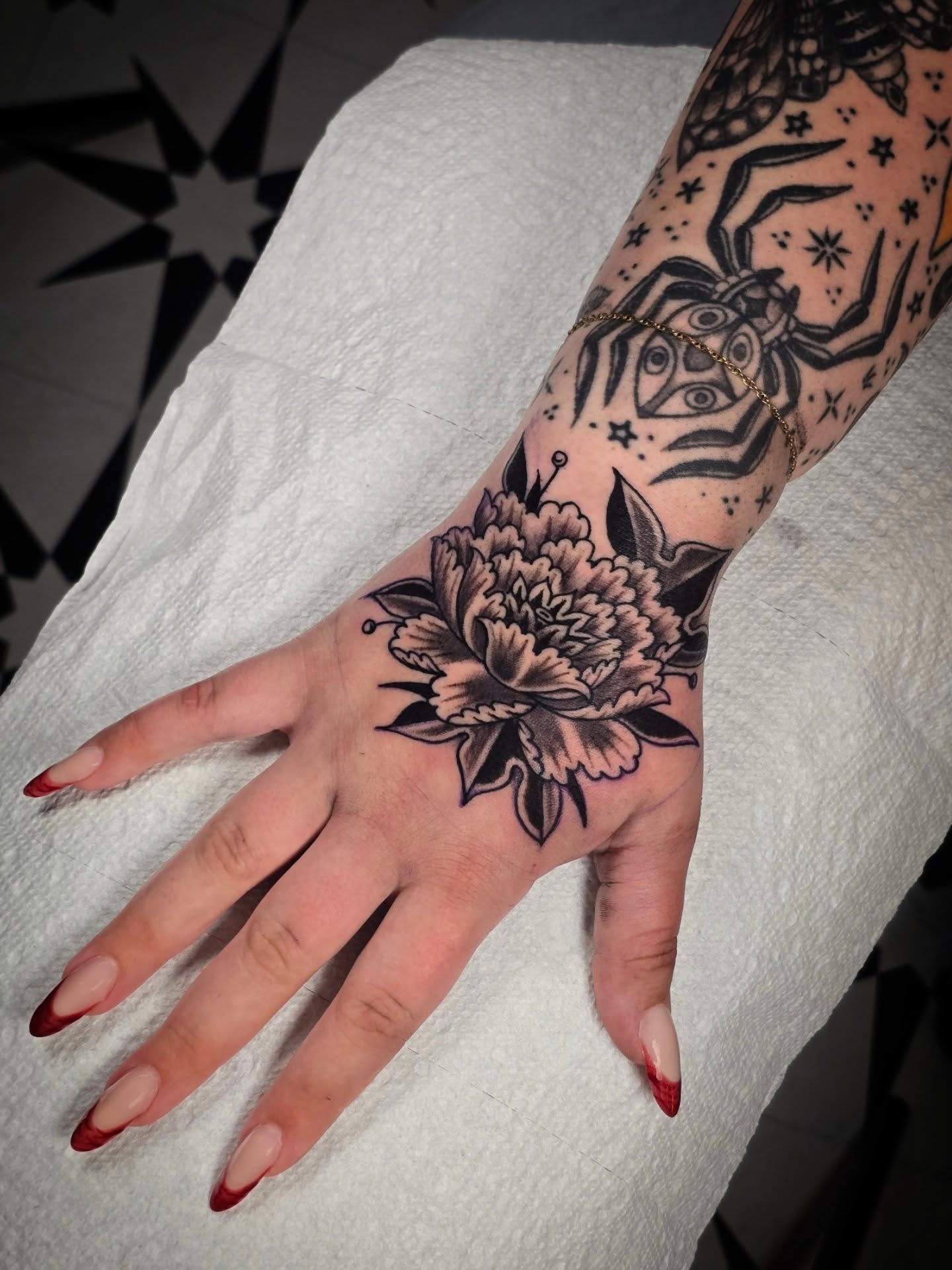 Peony flower American traditional tattoo on the hand by Aaron Dor