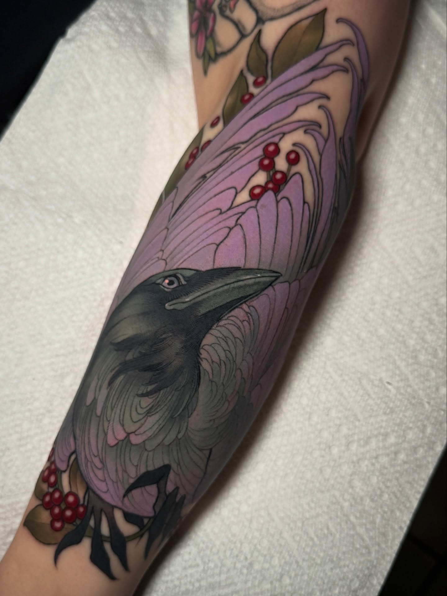 Crow and floral realism tattoo on the forearm by πππ±π±π¬π¬ ππ―π±π¦π°π±