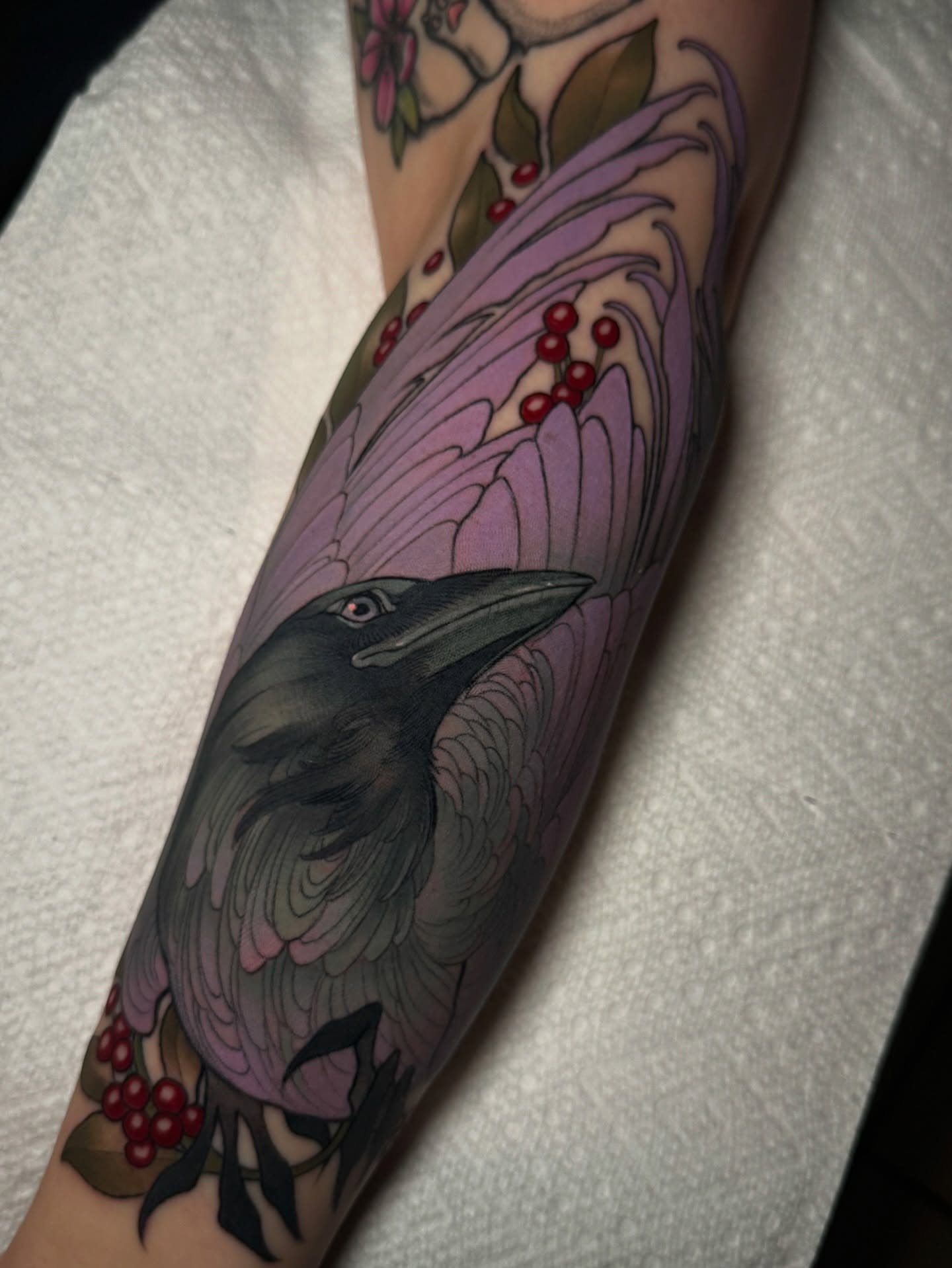 Crow and floral realism tattoo on the forearm by πππ±π±π¬π¬ ππ―π±π¦π°π±