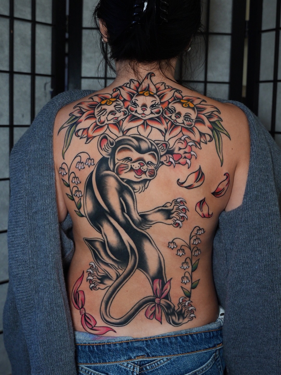 Cat and flowers American traditional tattoo on the back by Nori