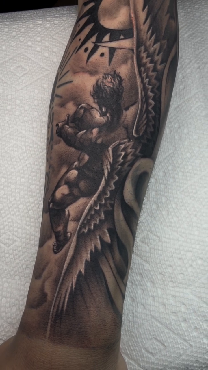Cherub with wings and sun realism tattoo by Denver Tattoo Artist