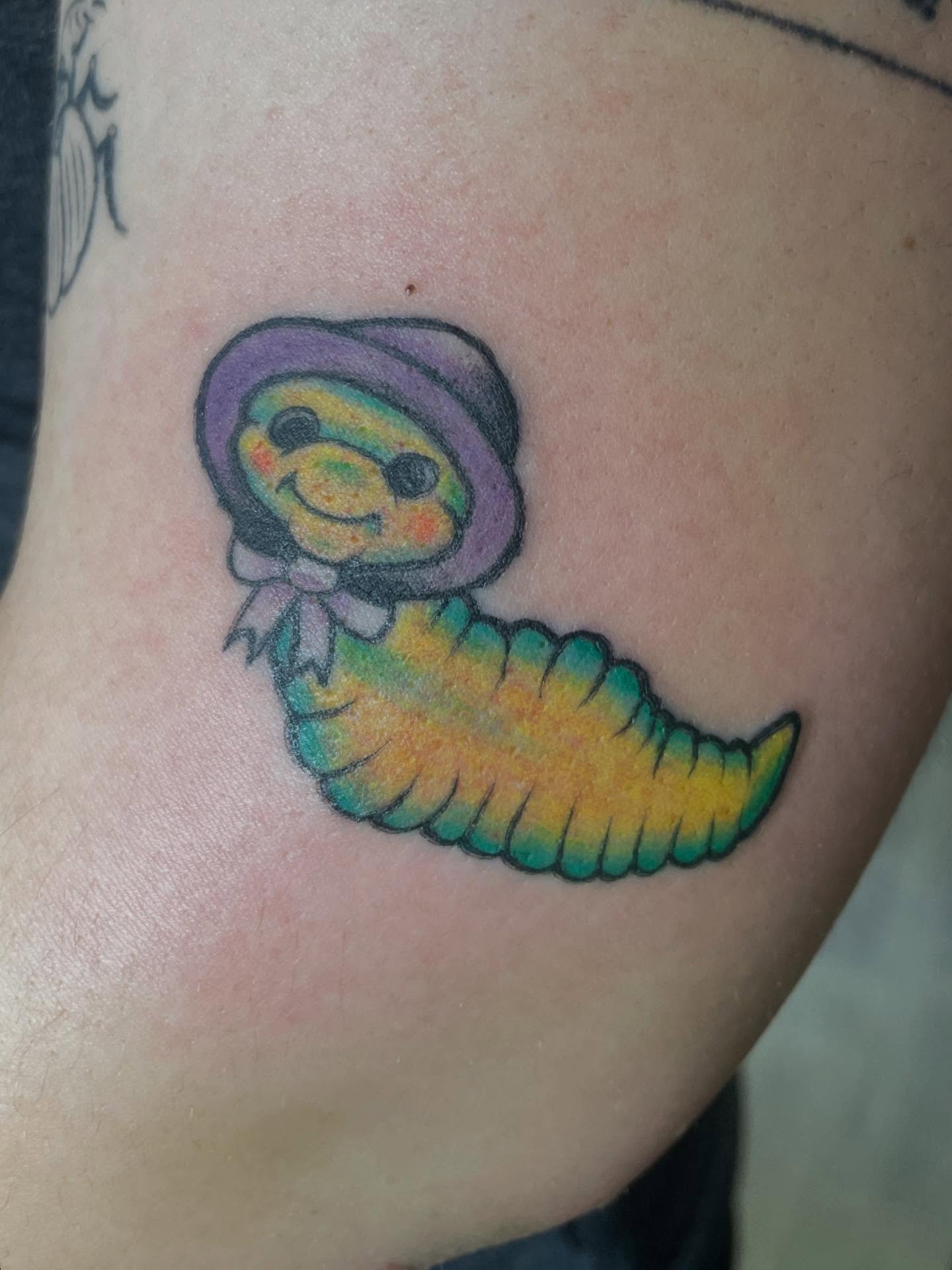 Worm with hat new school tattoo on the upper arm by 𓉸ྀི lola hoax tattoos𓉸ྀི