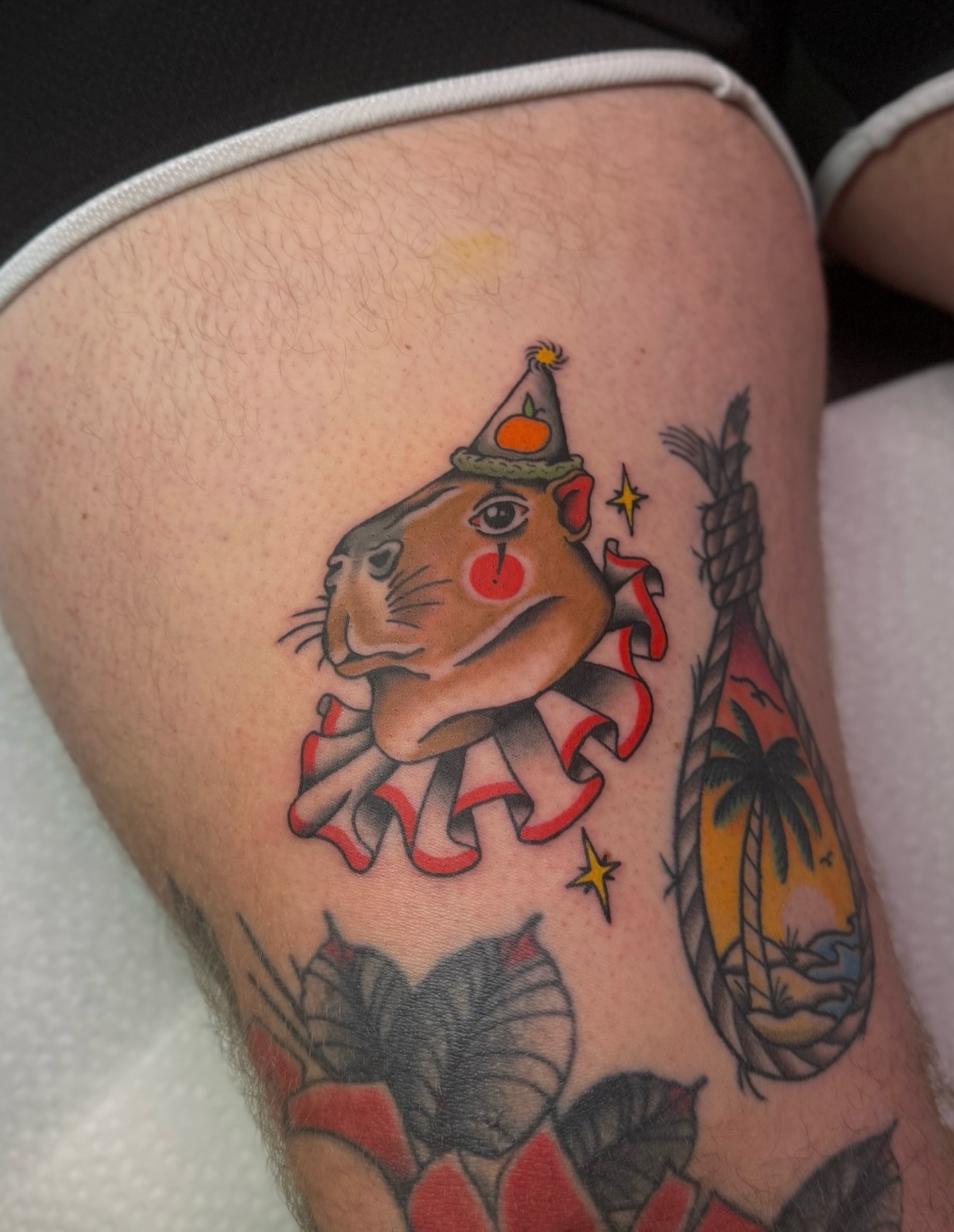 Hippo wearing party hat American traditional tattoo on the thigh by Ethan, Toledo, Ohio