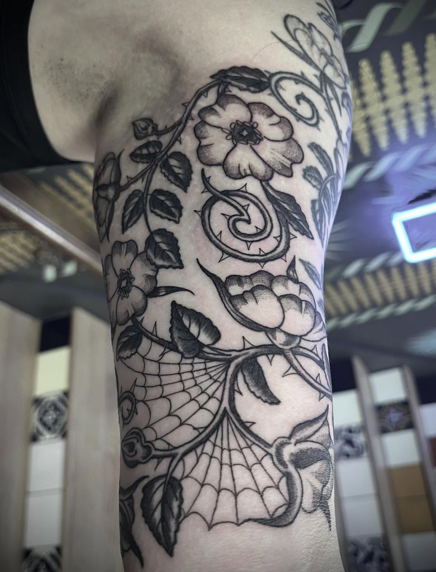 Flower and vine ornamental tattoo on the forearm by Natalie Phillips, Oakland, California