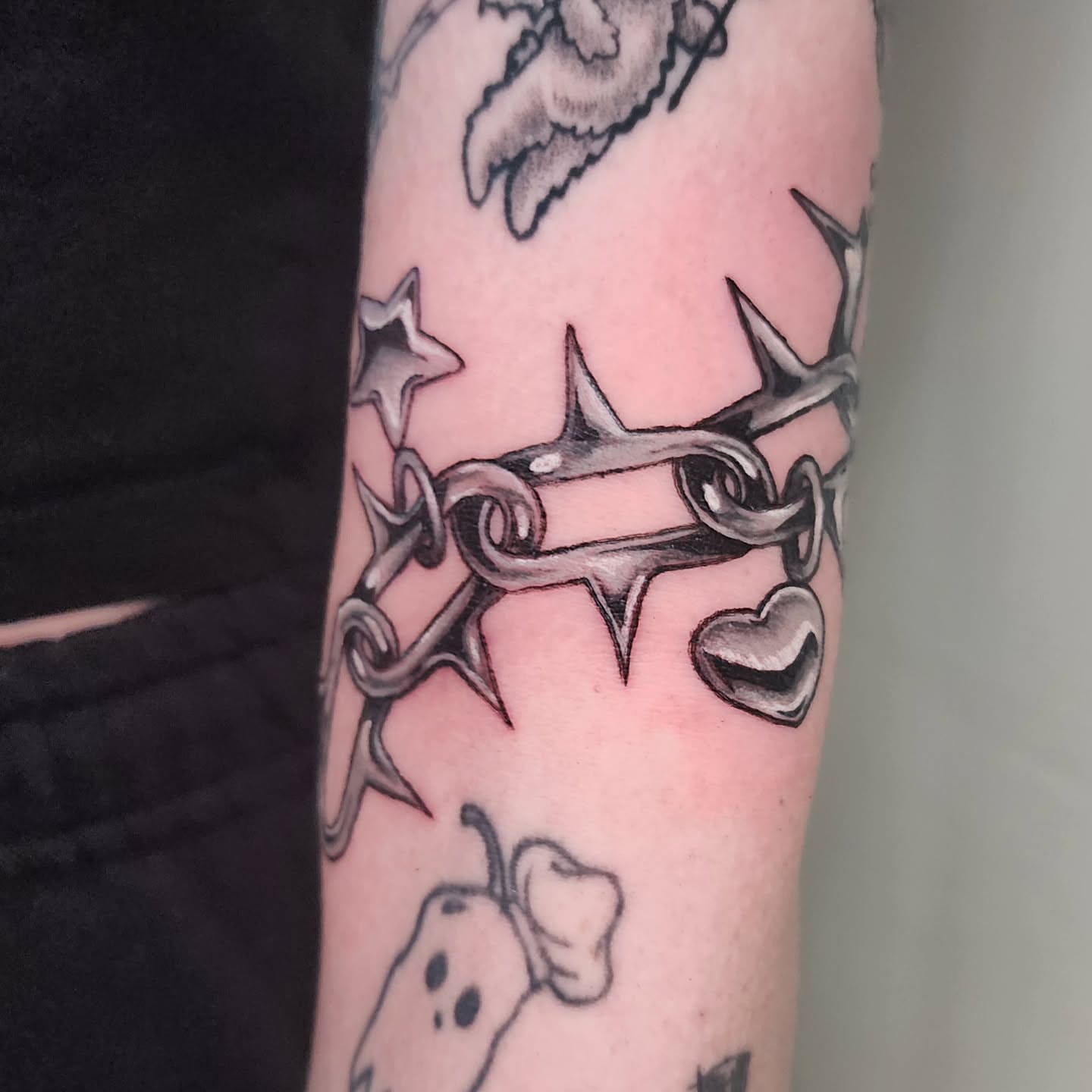 Barbed wire crown black and grey tattoo on the forearm by Lindsey Andrew, Englewood, Colorado